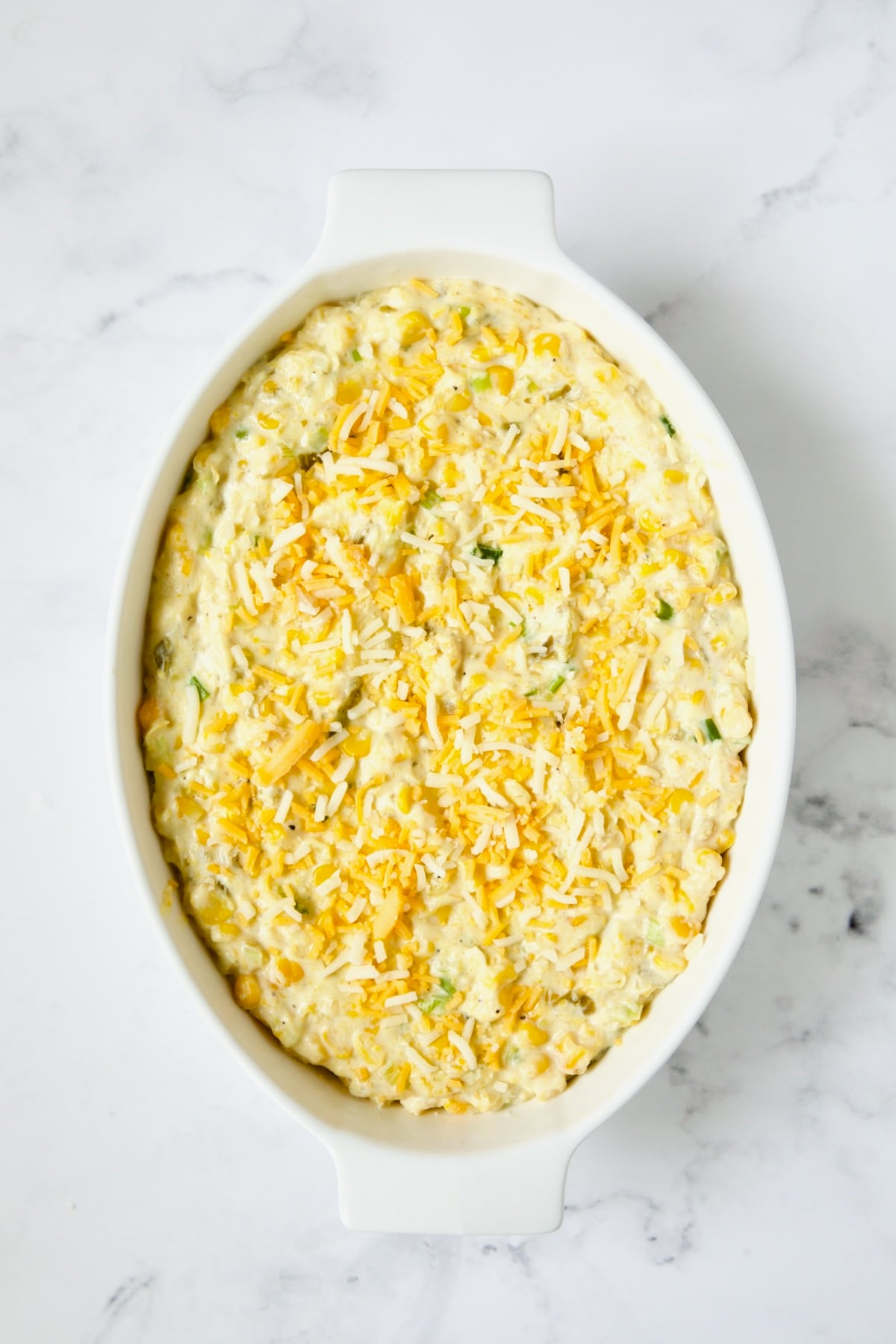 Finished casserole with cheese on top before being baked.