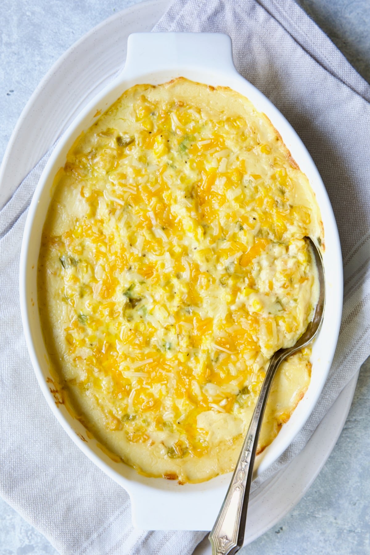 Cream Cheese Corn Casserole with Green Chiles in white oval baking dish after being baked.