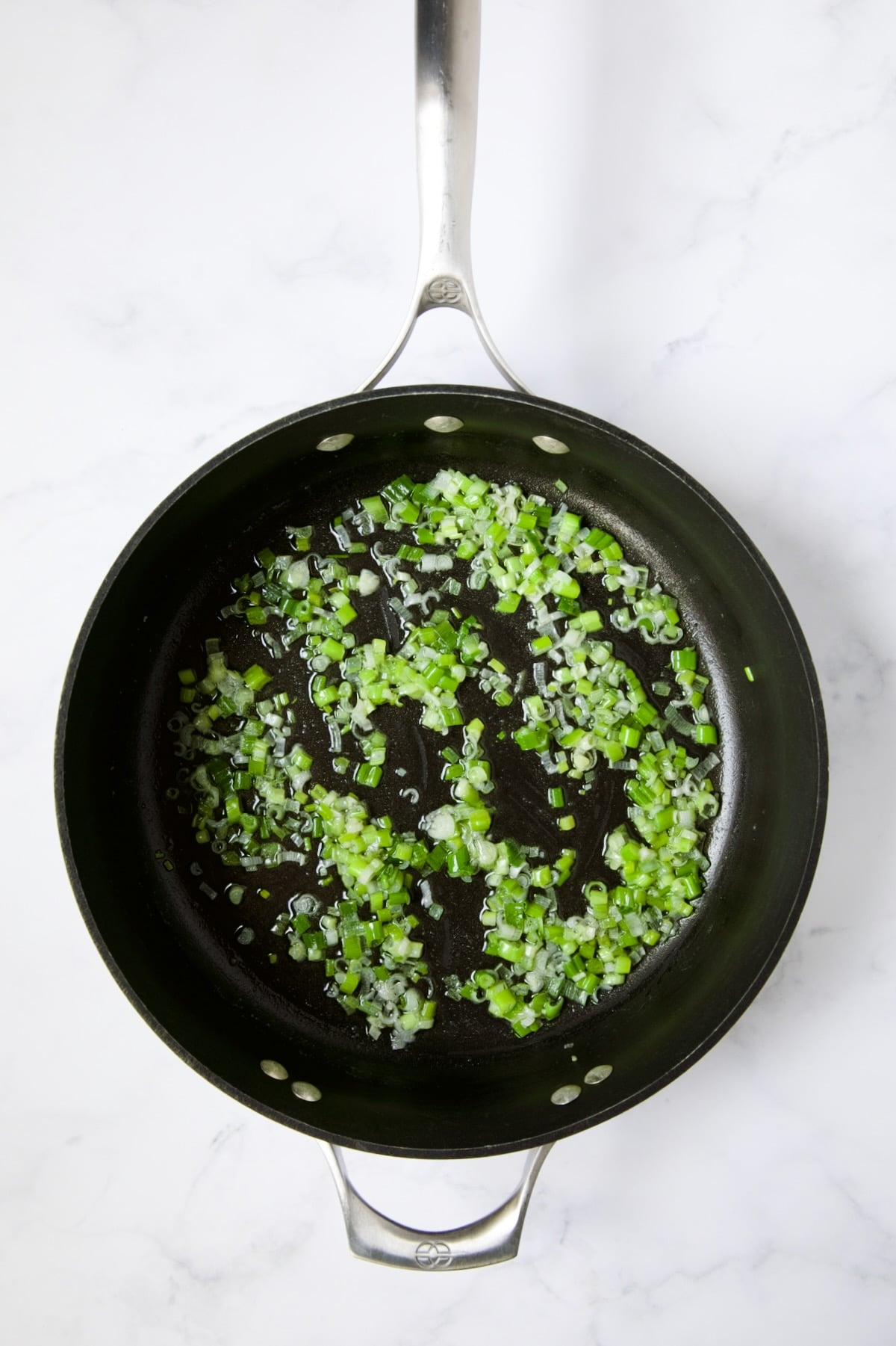 Cooked scallions in butter in nonstick skillet.