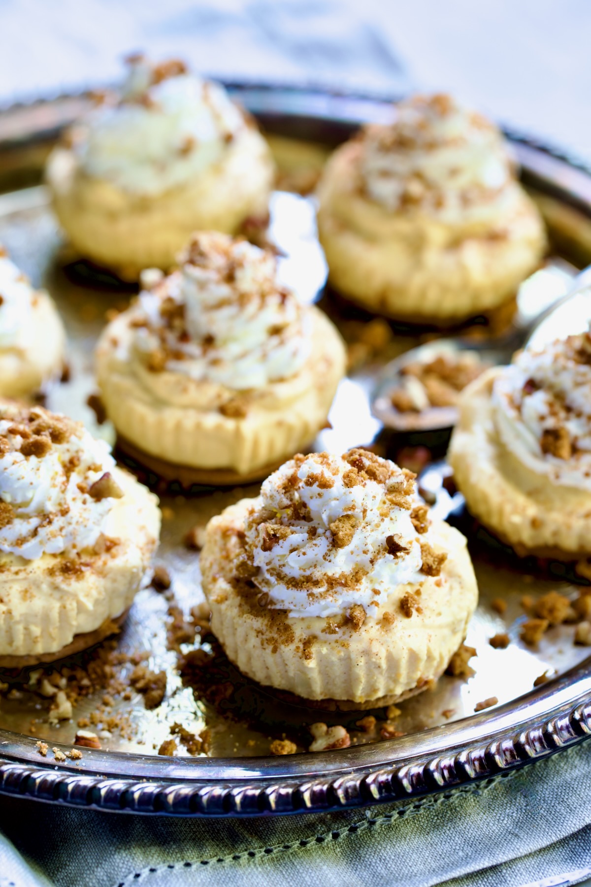 Seven Easy Mini No-Bake Pumpkin Cheesecakes on antique silver platter.