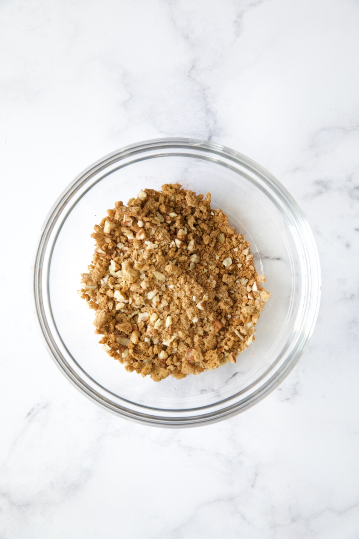 Gingersnap and pecan topping in glass bowl.