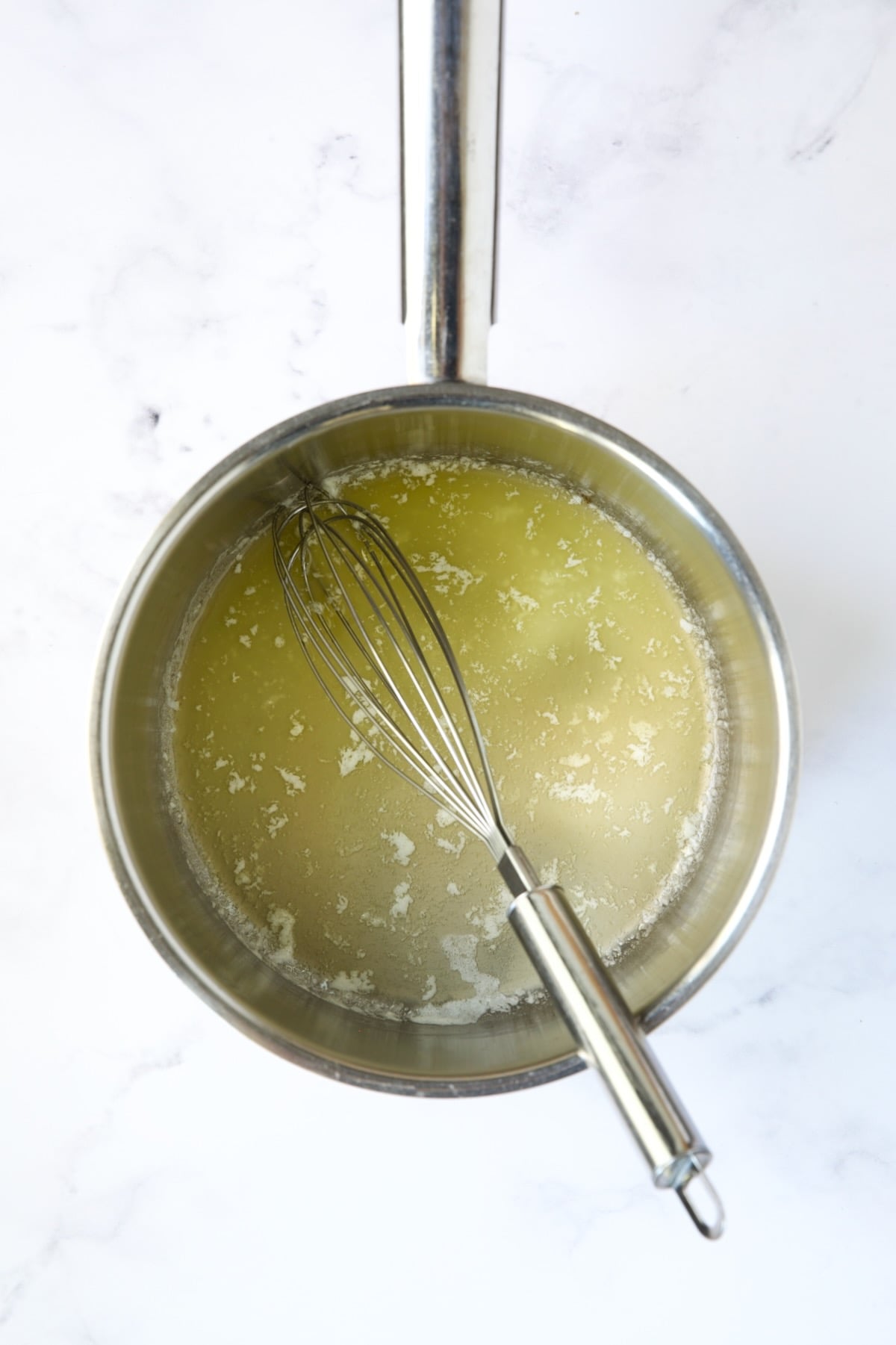 Melted butter and wire whisk in stainless steel saucepan.