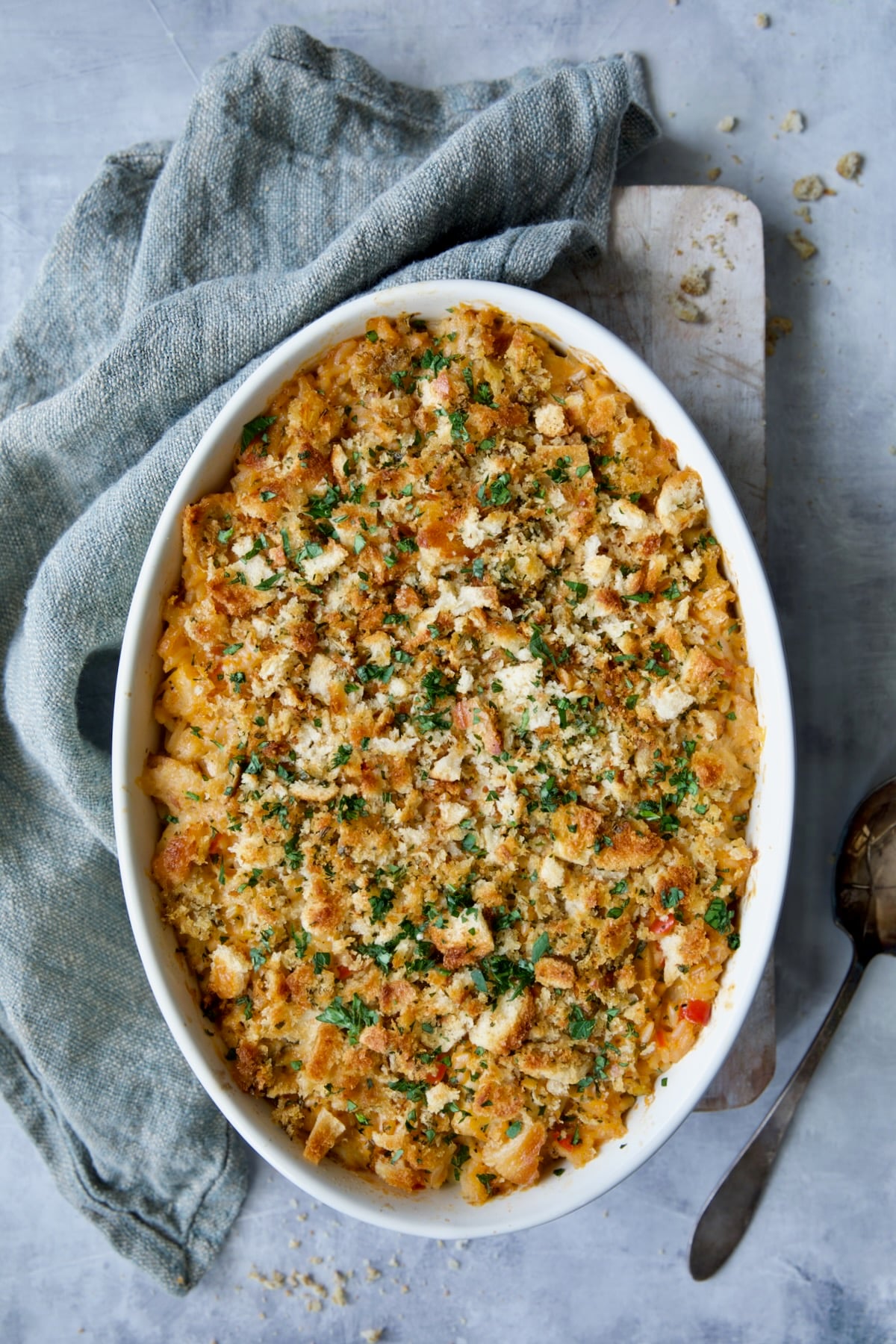 Baked Shrimp and Crab Seafood Casserole on blue background with blue napkin.
