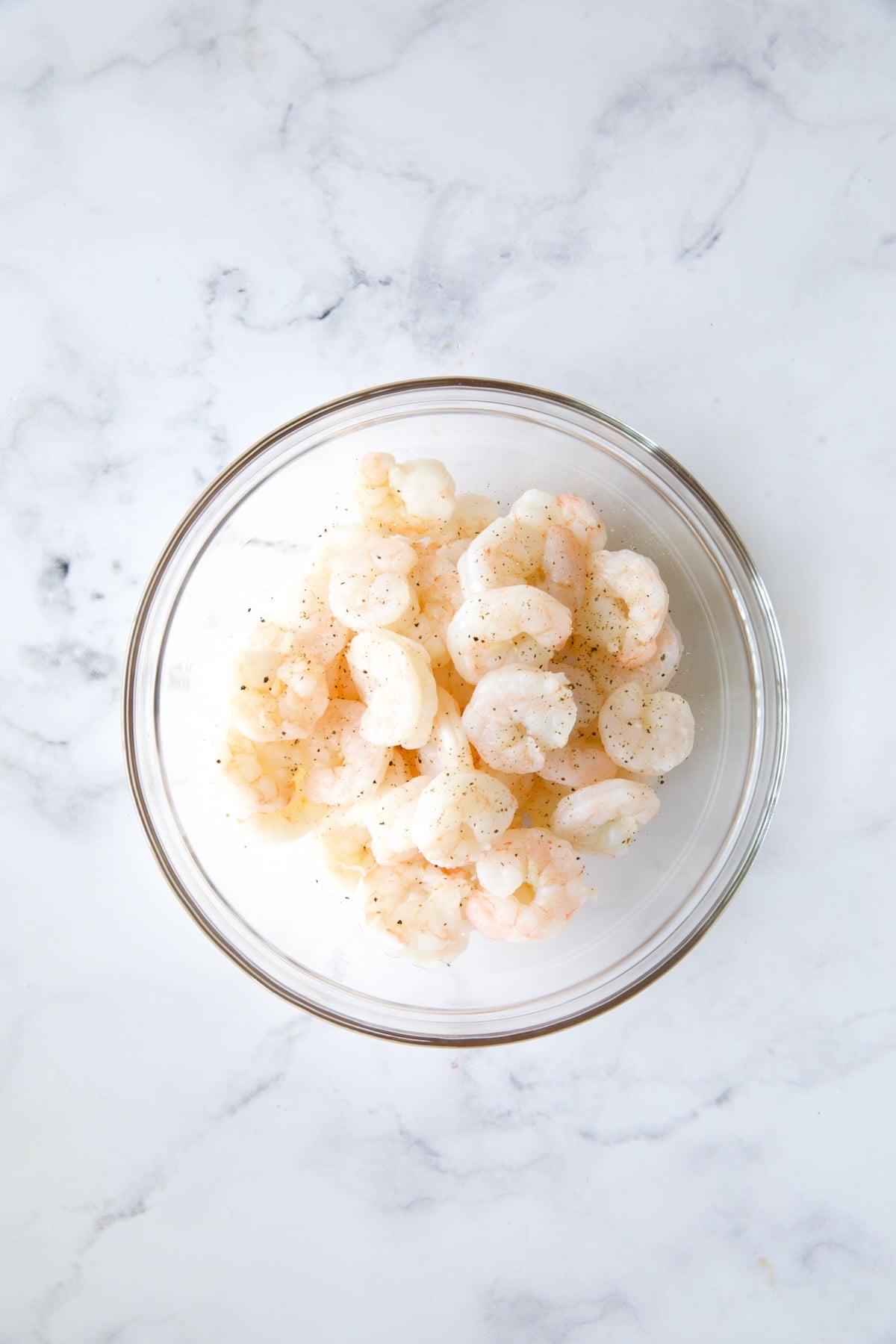 Cooked shrimp in glass bowl.