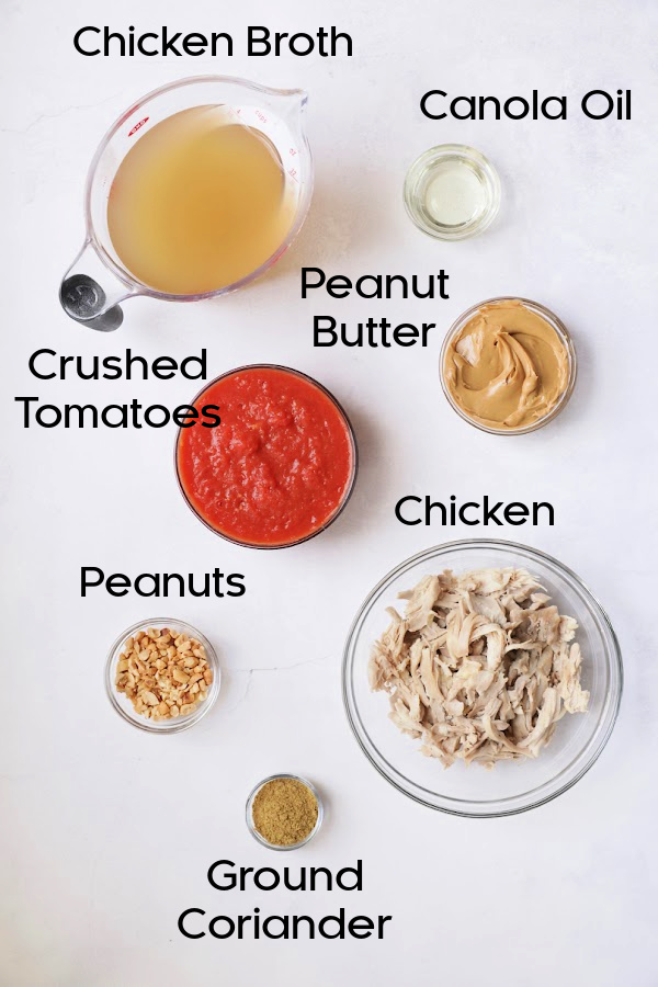 Ingredients for Spicy Chicken, Sweet Potato and Peanut Soup in glass bowls.