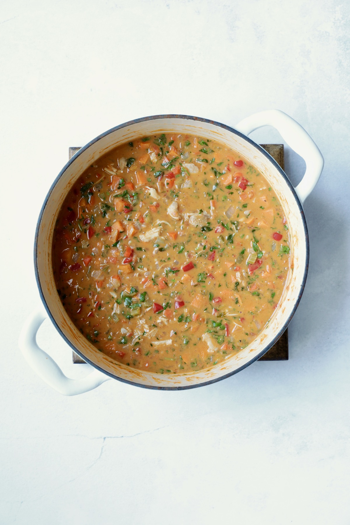 Soup in white Dutch oven after being simmered.