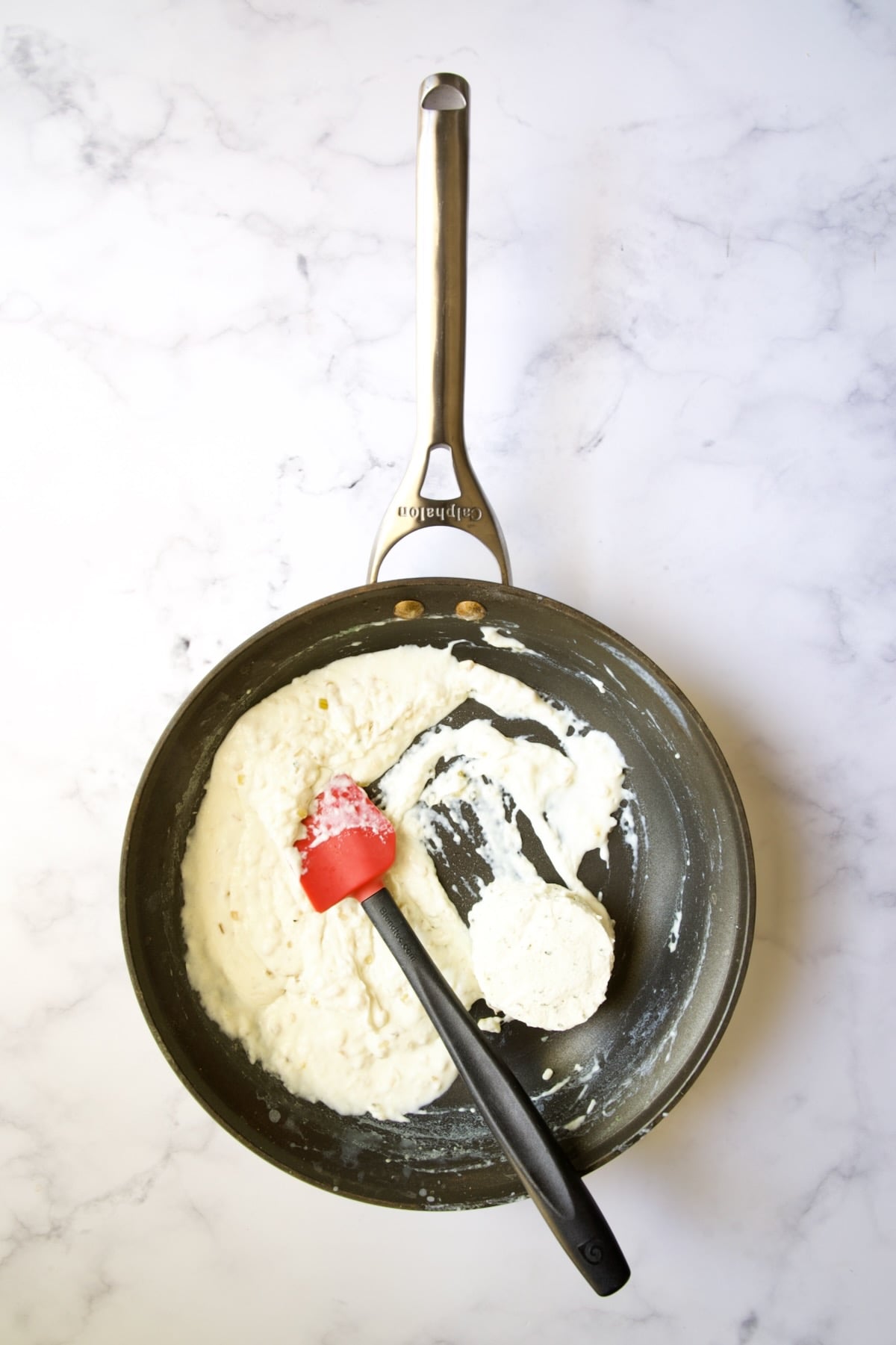 Thickened half and half in nonstick skillet with Boursin cheese added.