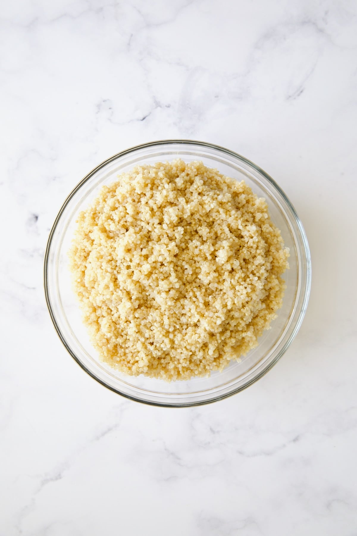 Cooked quinoa in glass bowl.