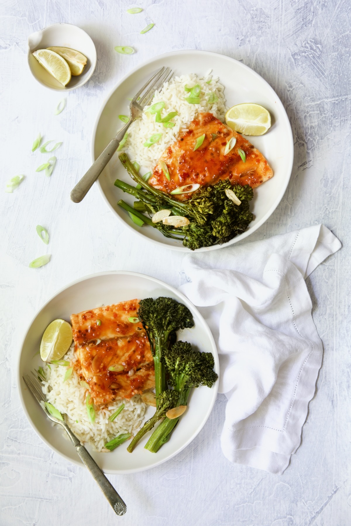 Two servings of Sheet Pan Thai Baked Fish with Broccolini on white plates.