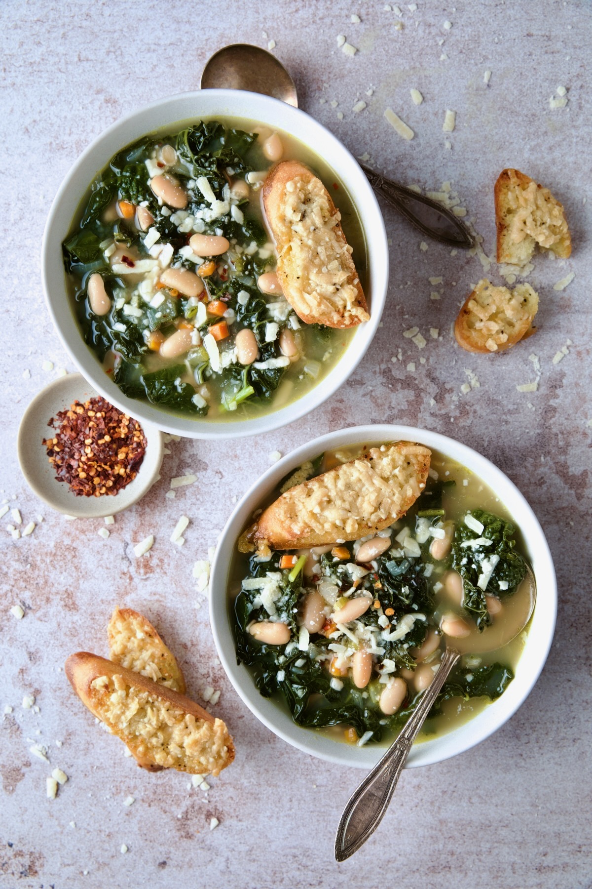 Two bowls of White Bean Kale Soup with Parmesan Toast.