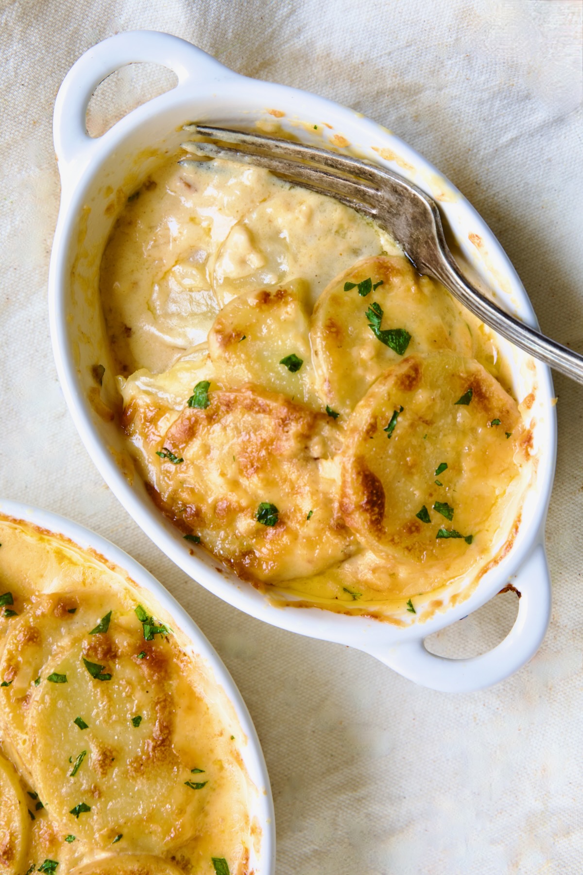 One dish of Au Gratin Potatoes for Two with fork digging into it.