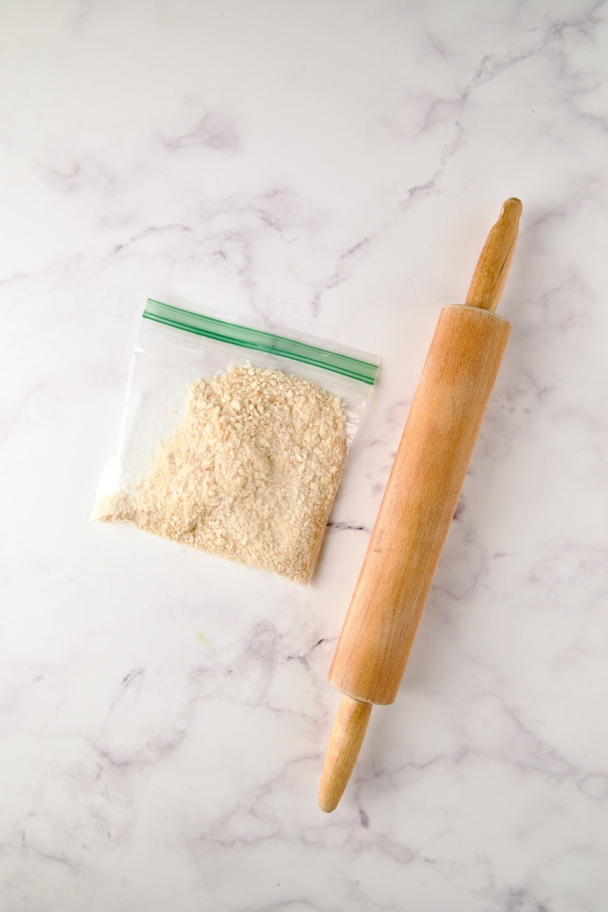 Crushed Saltine crackers in sandwich bag with rolling pin.