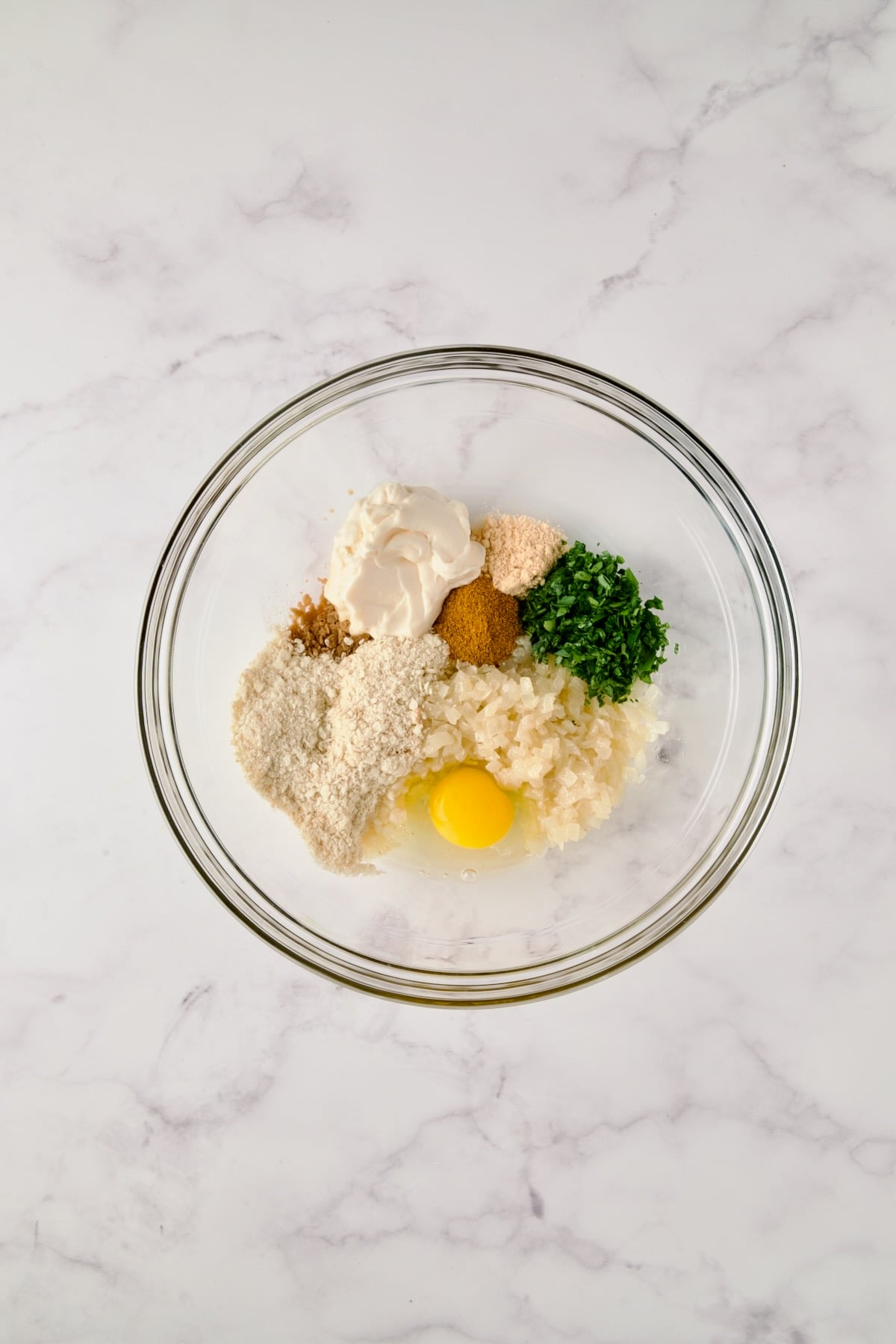 Ingredients for Maryland-Style Crab Cakes in glass bowl before being combined.