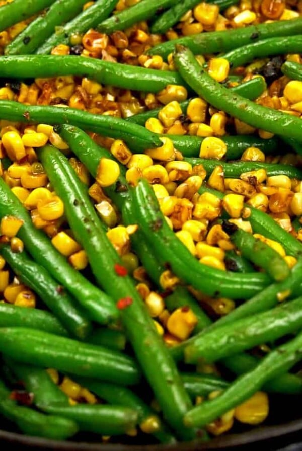 Corn and green beans in cast iron skillet.