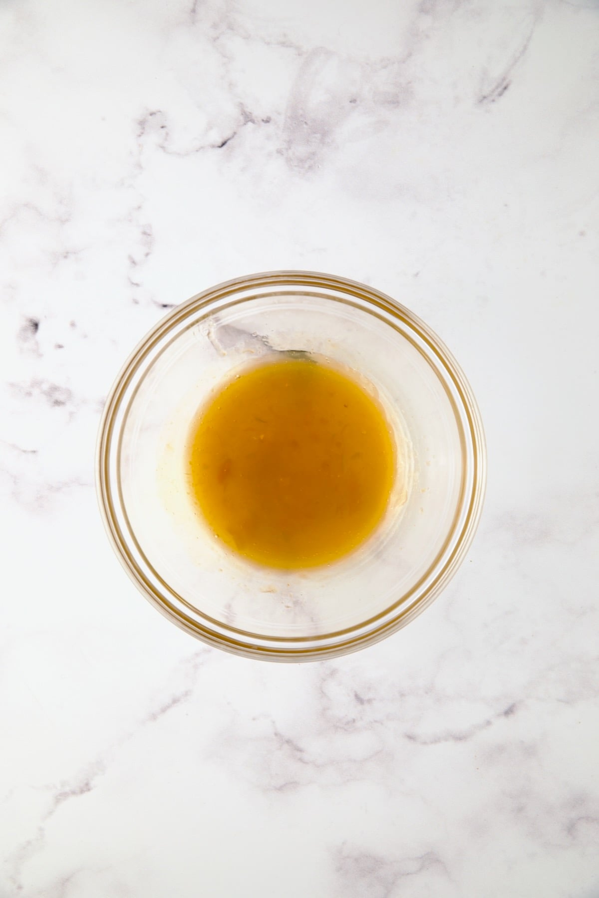 Apricot preserves and cider vinegar in glass bowl.