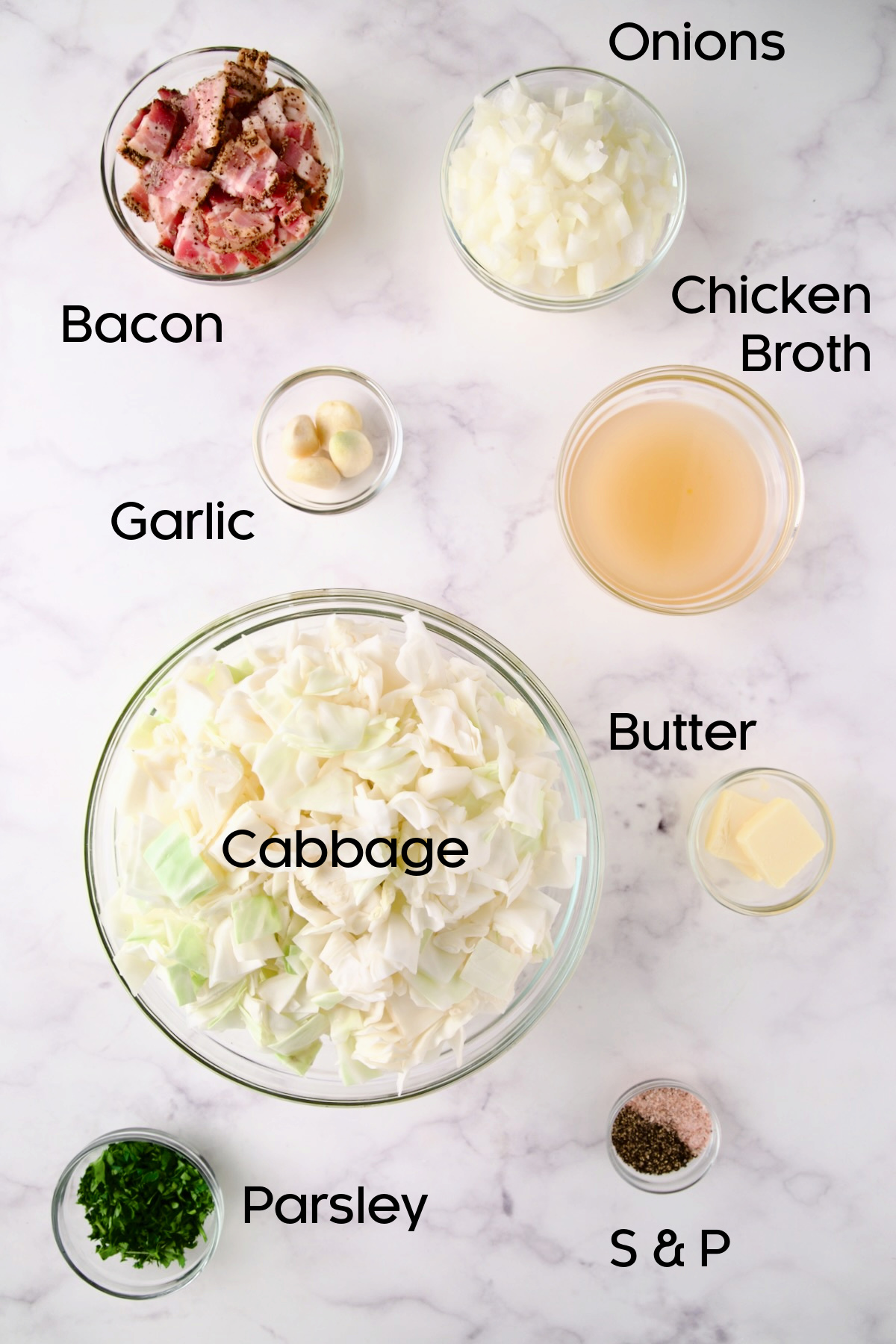 Ingredients for Fried Cabbage with Bacon in glass bowls.
