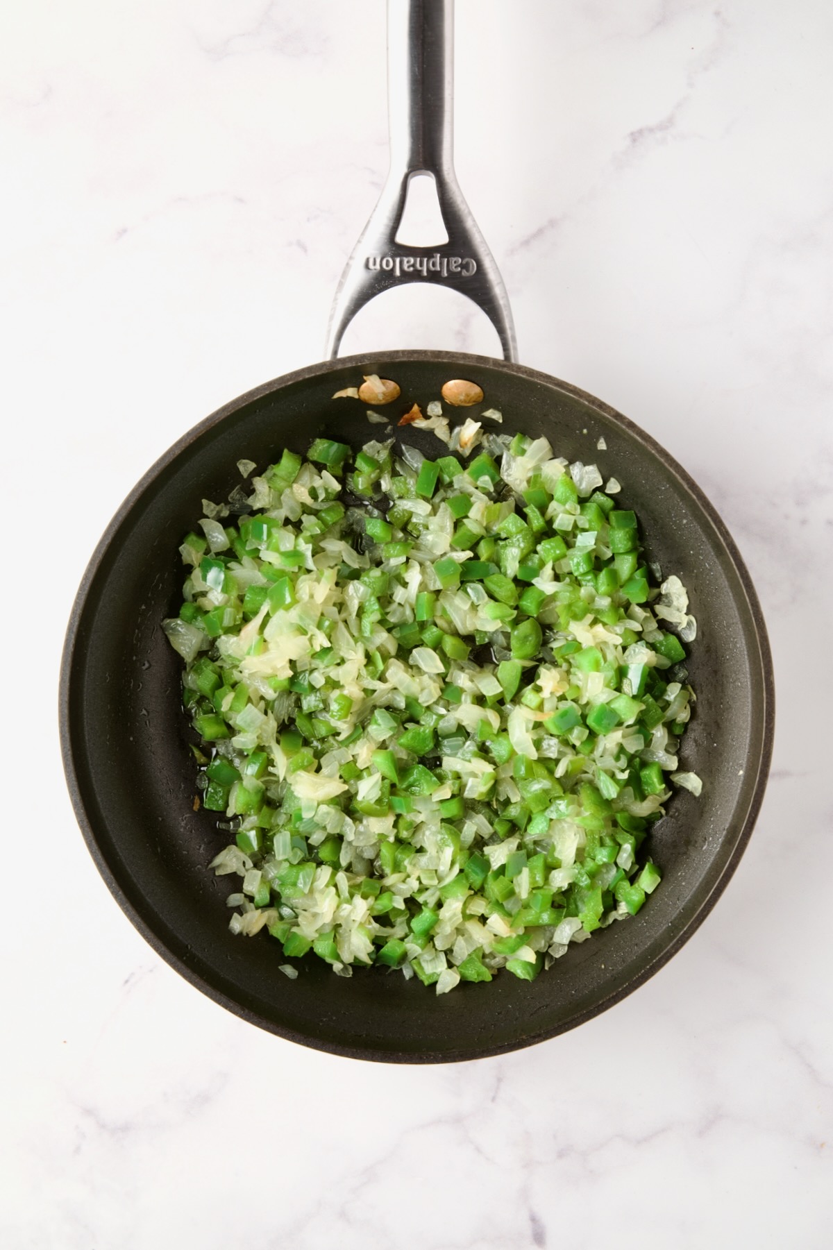 Cooked onions and green peppers in nonstick skillet.