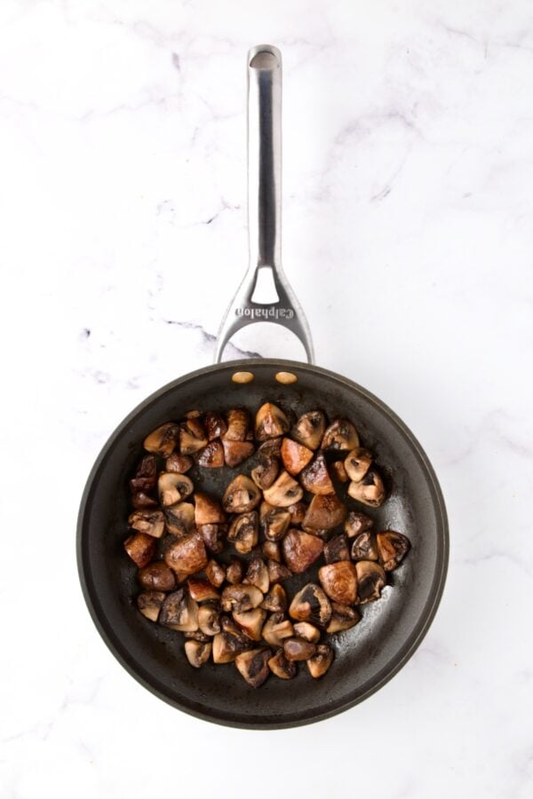 Sauteed mushrooms in nonstick skillet.