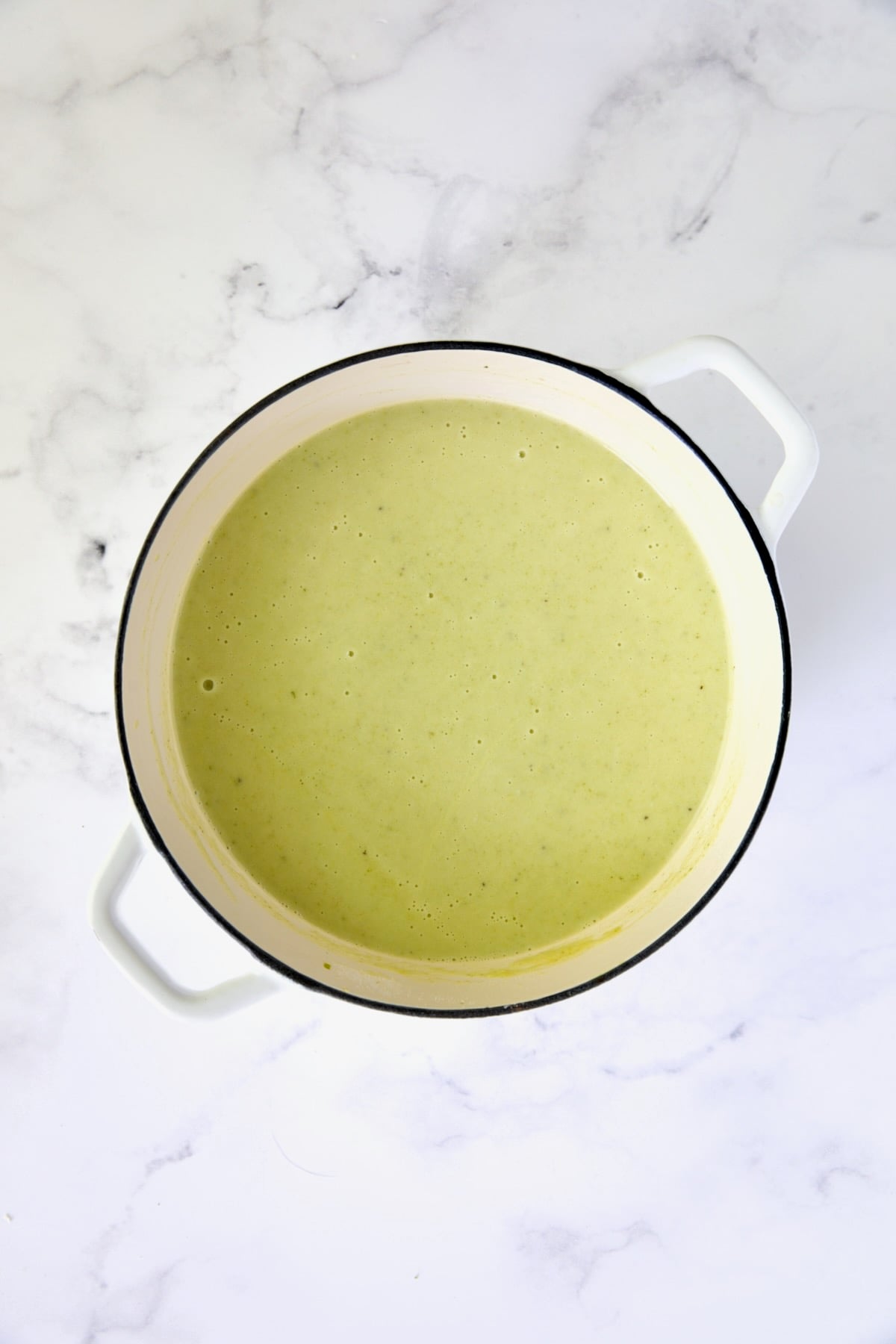 Cream of Celery Soup in white Dutch oven after being pureed.