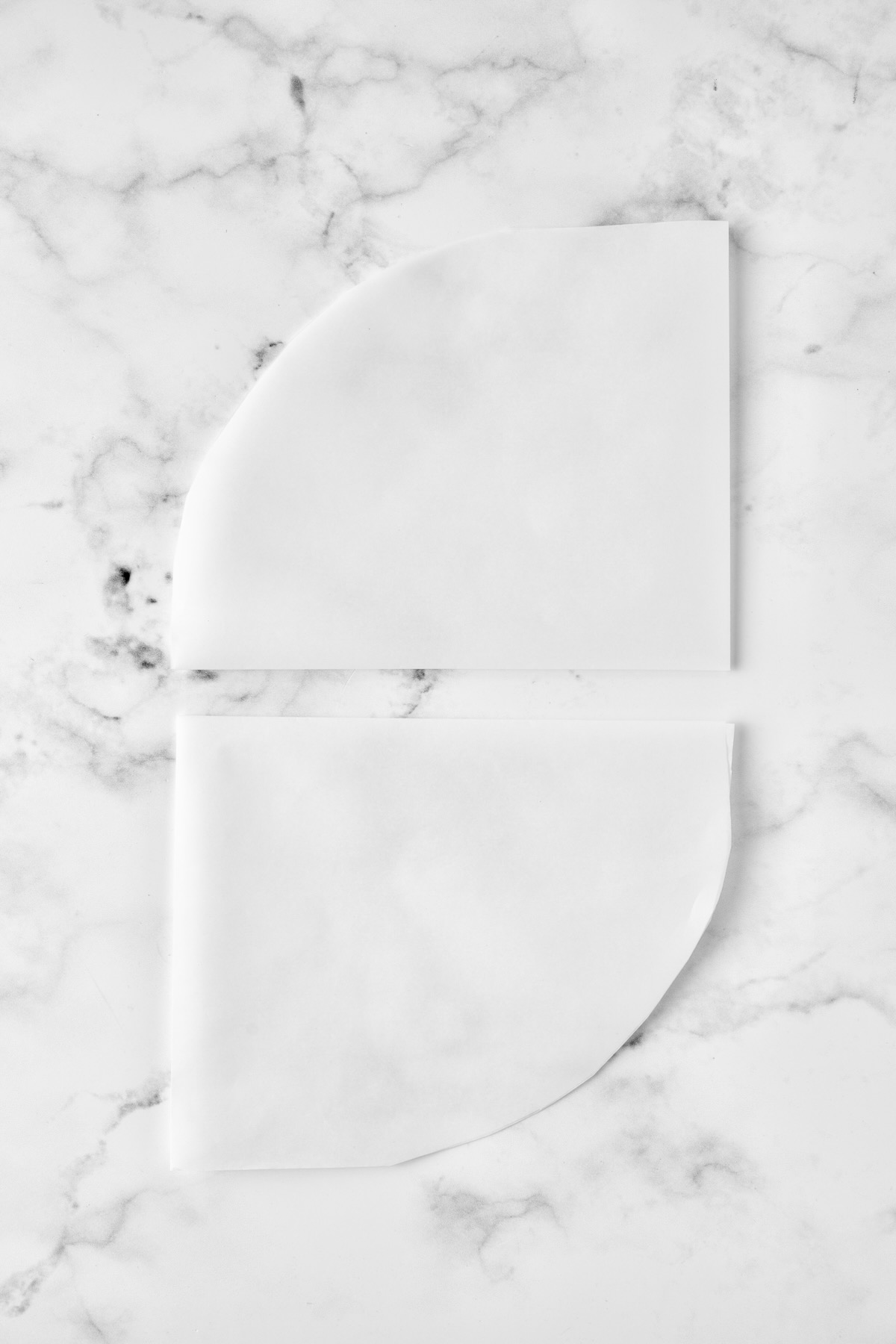 Two folded pieces of parchment paper.