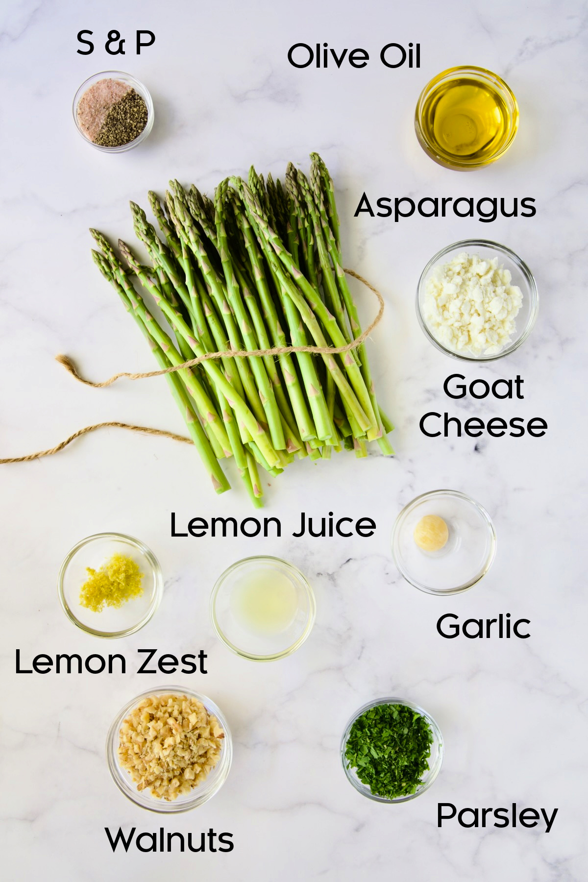 Ingredients for Roasted Asparagus with Walnut Lemon Gremolata and Goat Cheese in glass bowls.