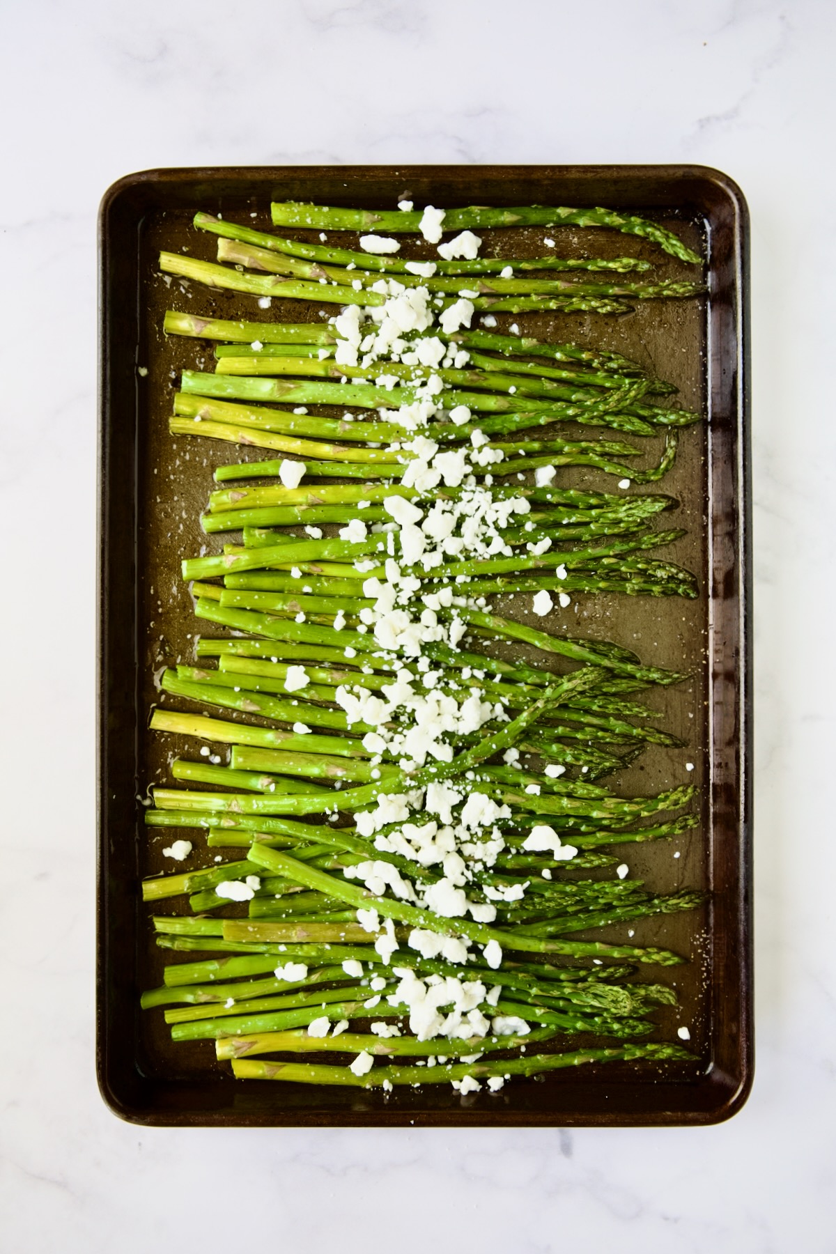 Roasted asparagus sprinkled with goat cheese.