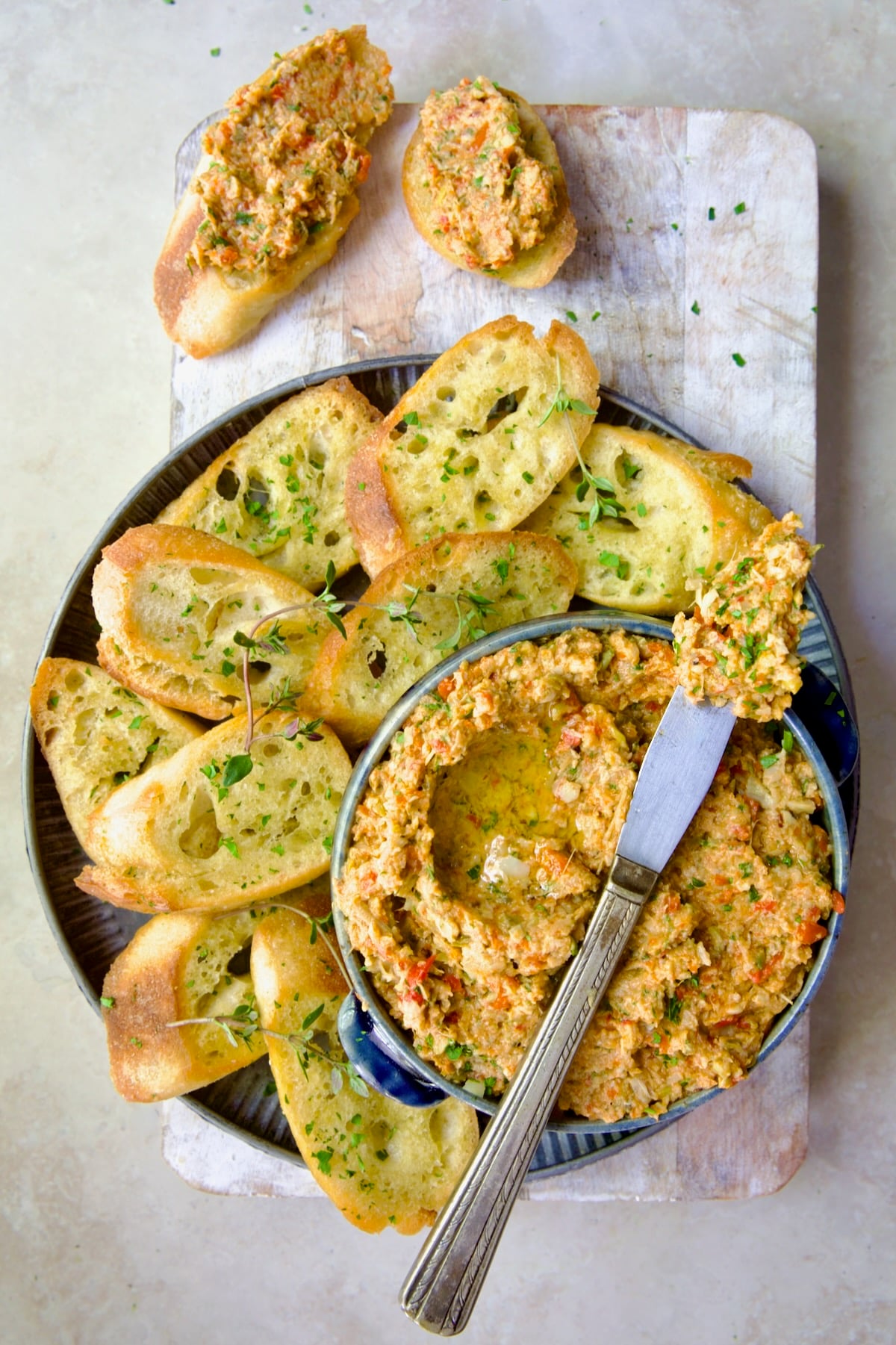 Artichoke Tapenade with Crostini on whitewashed board.