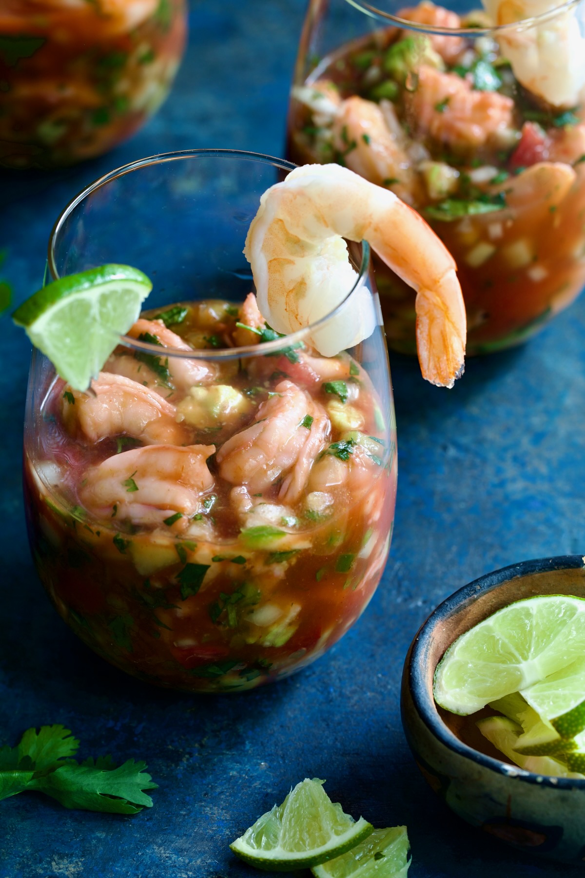 Mexican Shrimp Cocktail in glass garnished with lime wedge and shrimp.