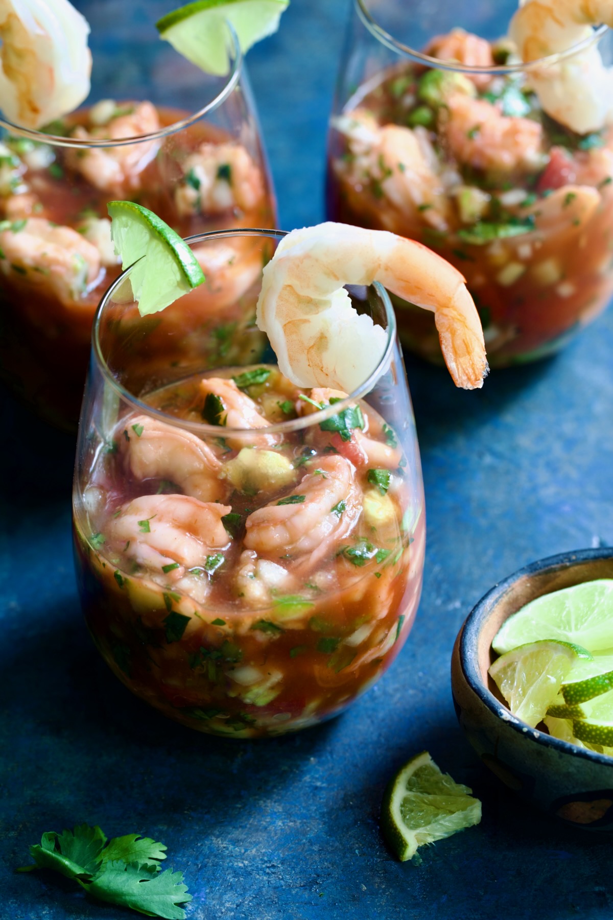 Mexican Shrimp Cocktail in glass garnished with lime wedge and shrimp.