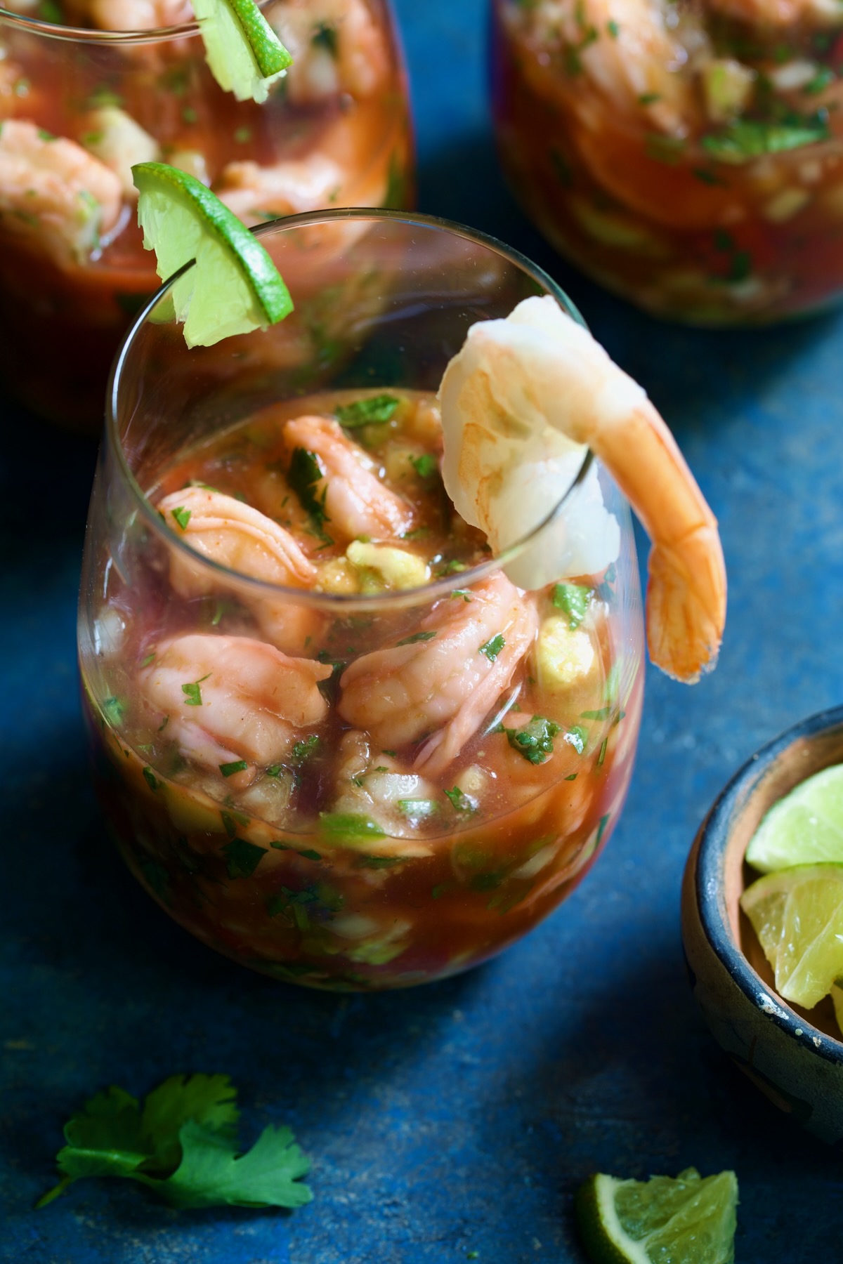 Mexican Shrimp Cocktail in glass garnished with lime wedge and shrimp.