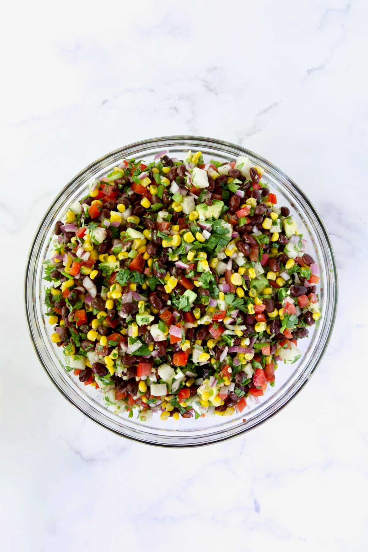 Ingredients for Southwestern Salad after being combined in glass bowl.