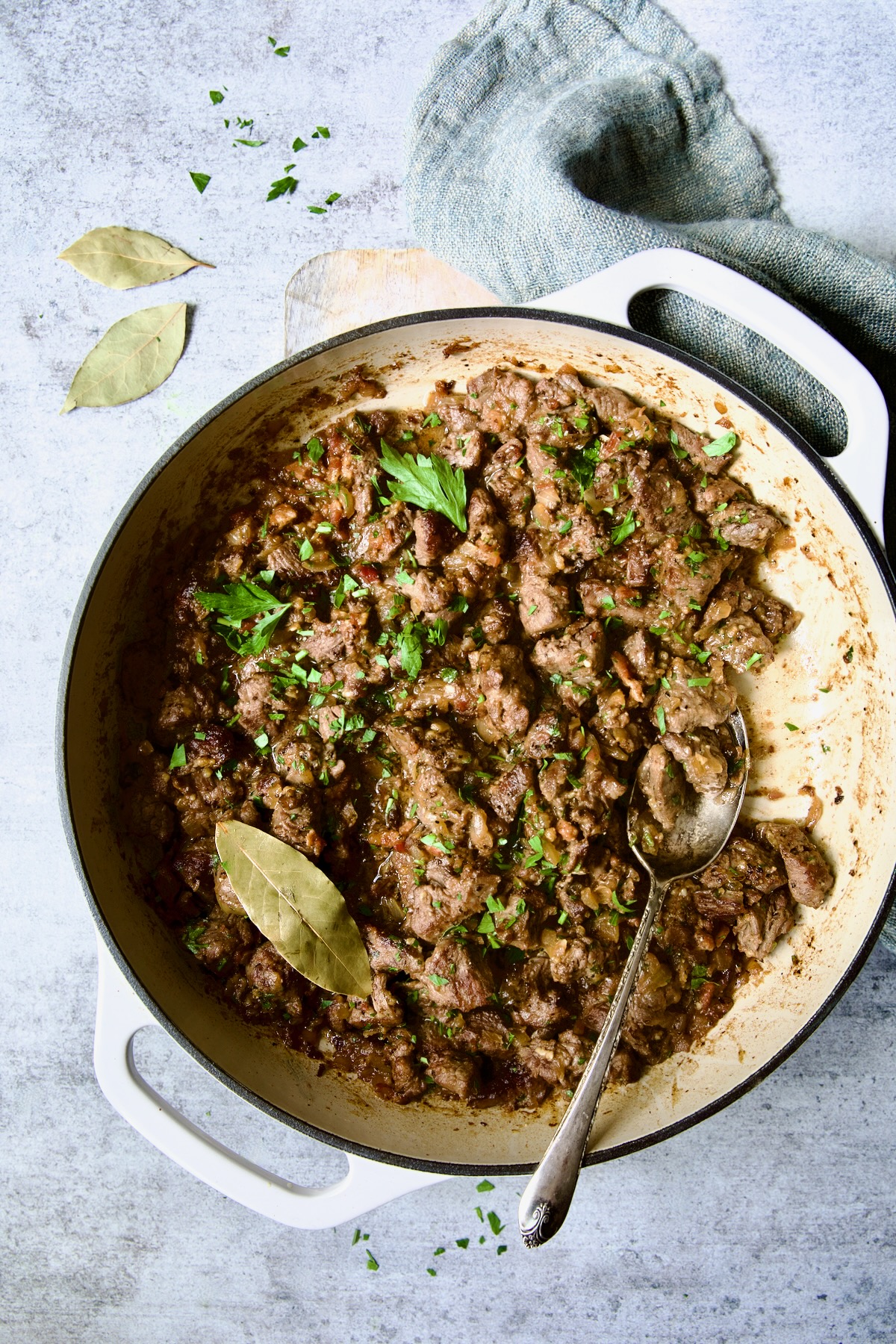 Beef Tips in Beer Sauce in white enamel cast iron skillet.