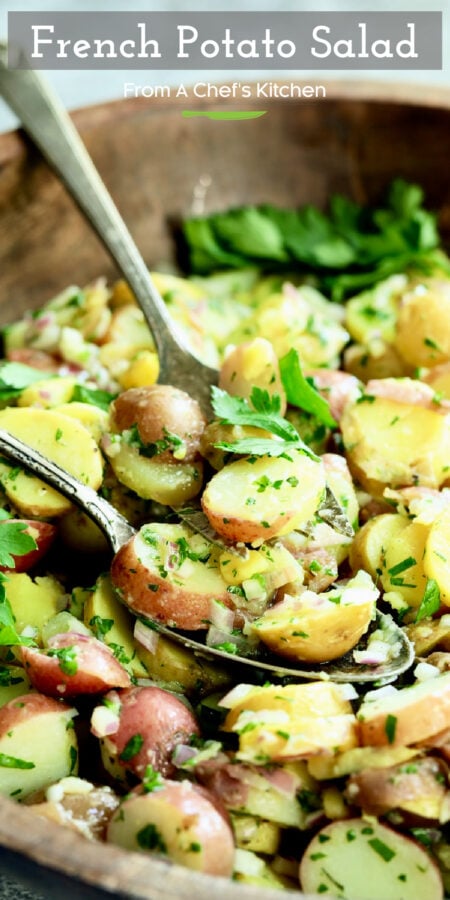 Pinterest graphic for French Potato Salad showing it in a wooden bowl with two utensils scooping some up.
