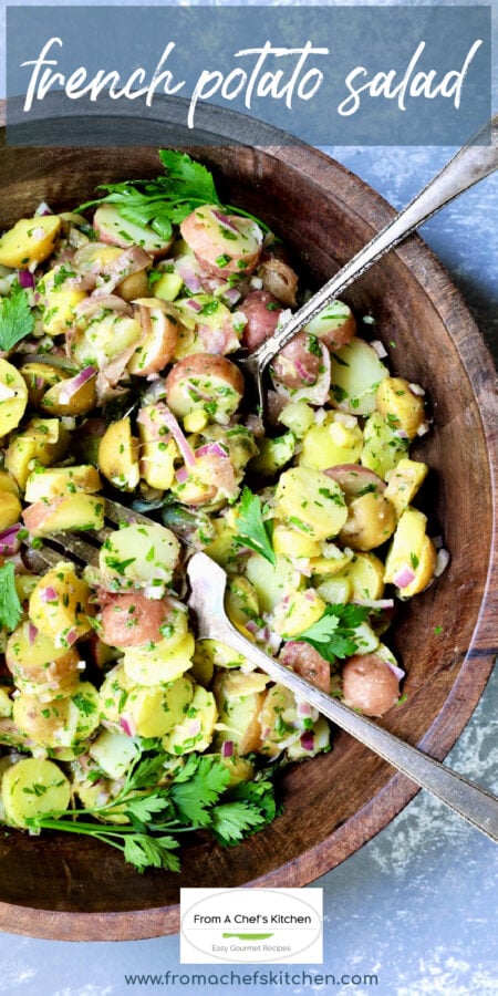Pinterest graphic for French Potato Salad showing it in a dark wood bowl with serving utensils.