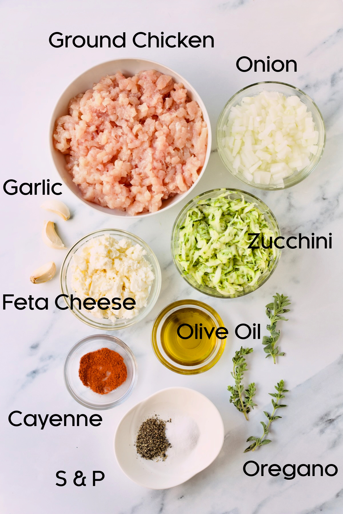 Ingredients for ground chicken burgers in bowls on countertop.