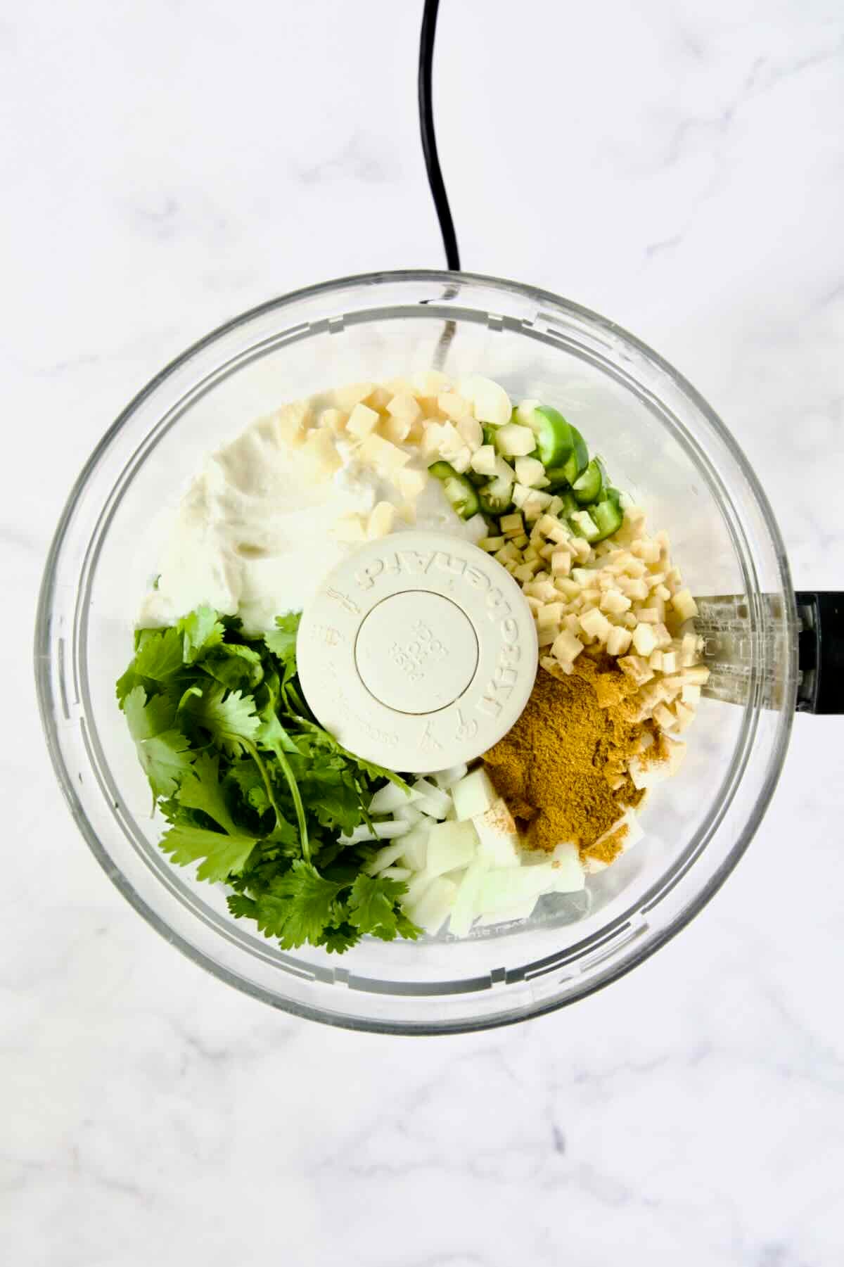 Ingredients for yogurt marinade in food processor before being pureed.