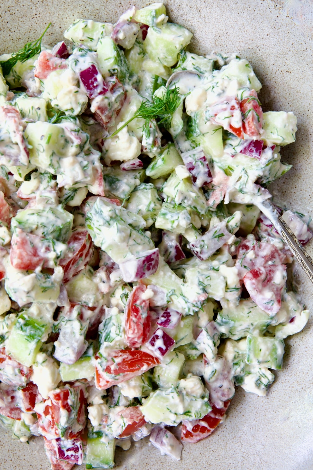 Cucumber Tomato Feta Salad with serving spoon.