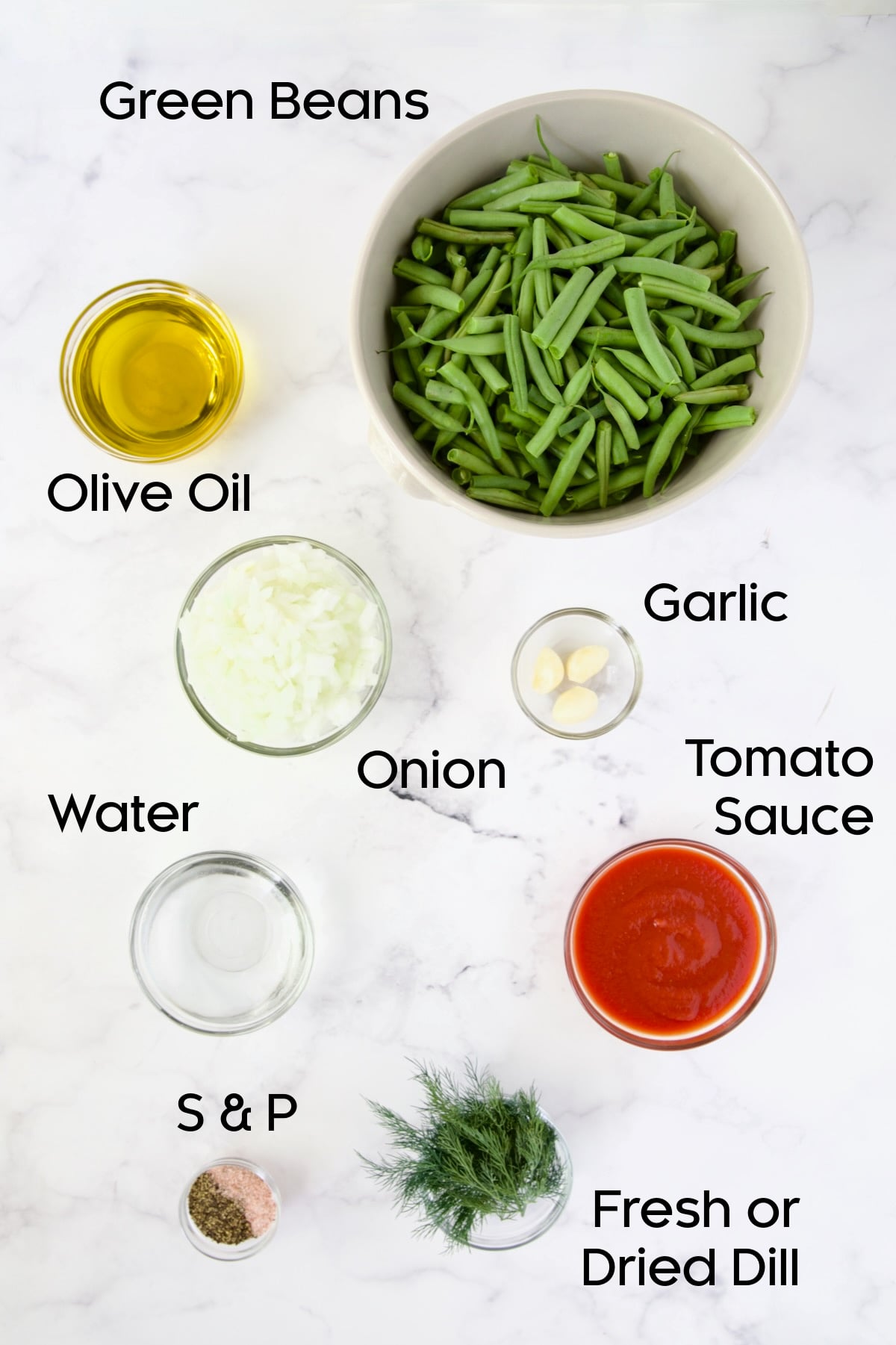 Ingredients for Greek Green Beans in bowls on countertop.
