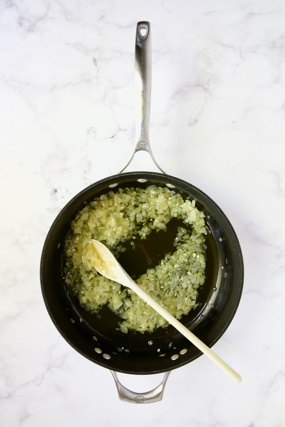 Onions being sauteed in nonstick skillet.