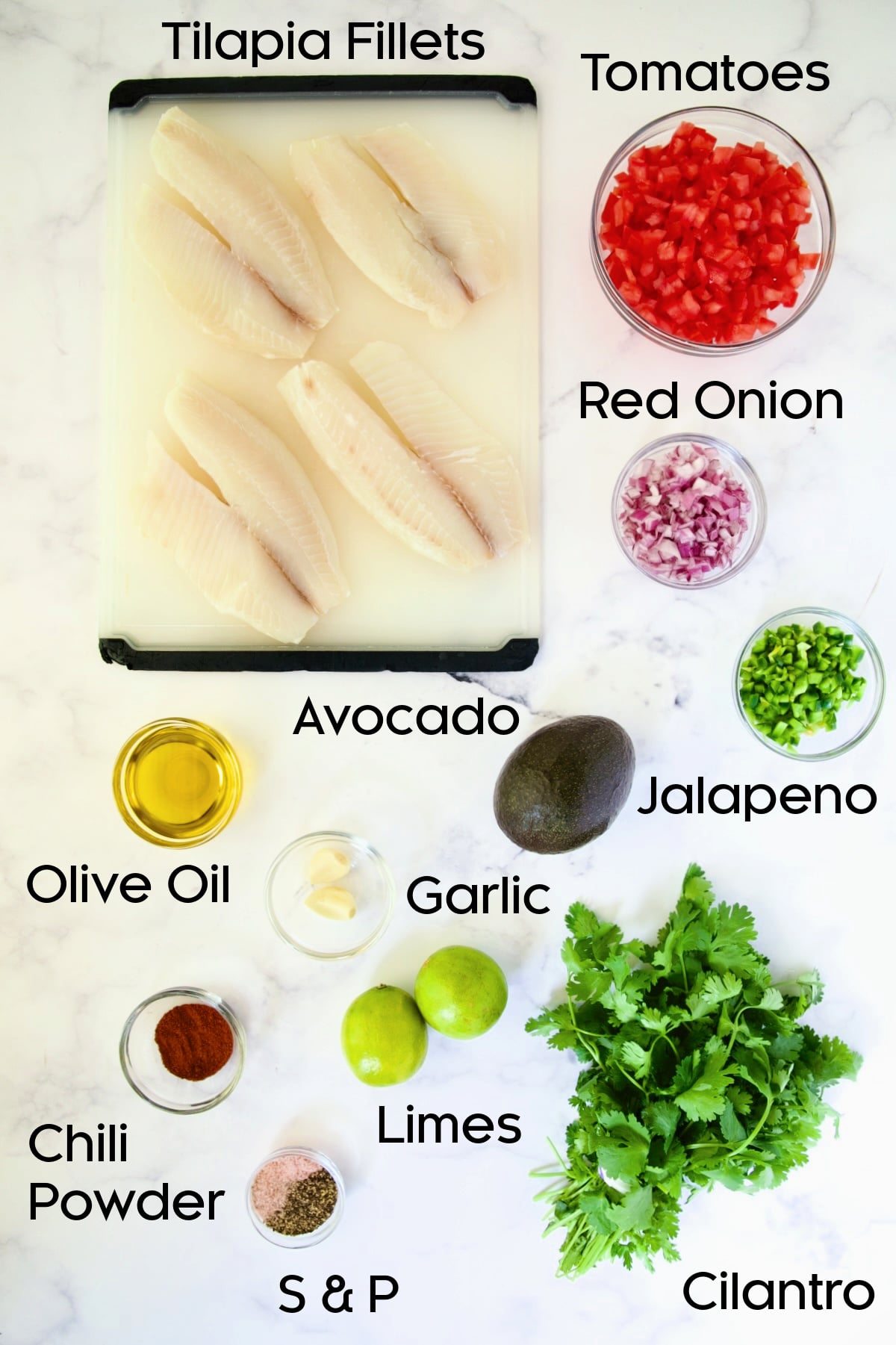 Ingredients for Grilled Tilapia with Tomato - Avocado Salsa on marble countertop.