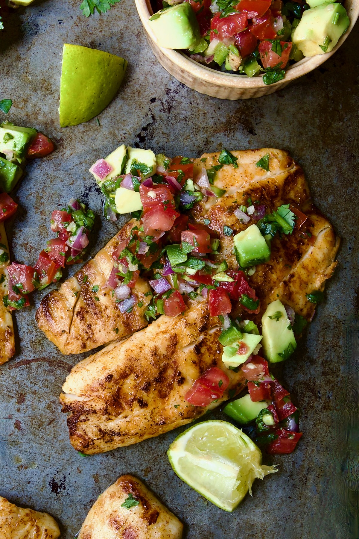 One piece of Grilled Tilapia with Tomato - Avocado Salsa.