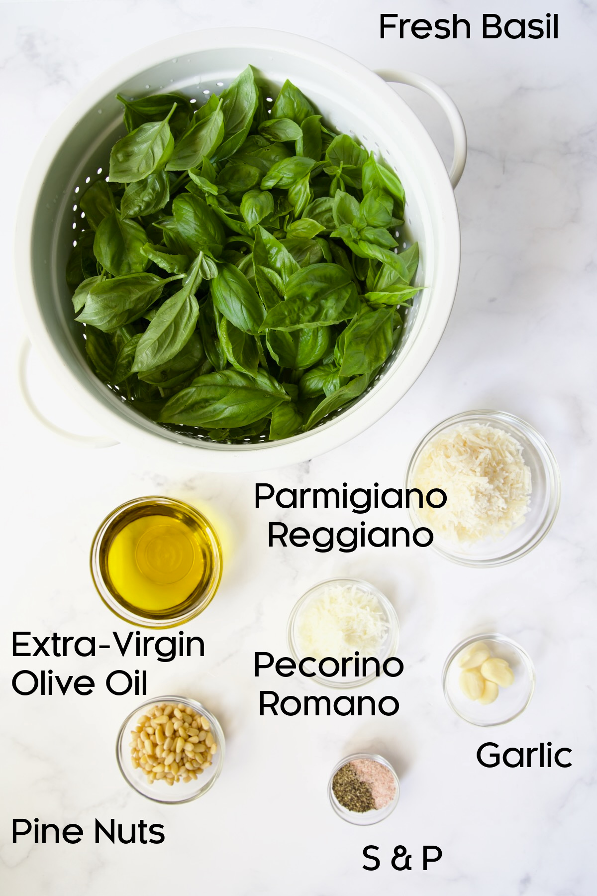 Ingredients for Pesto Genovese on marble countertop.