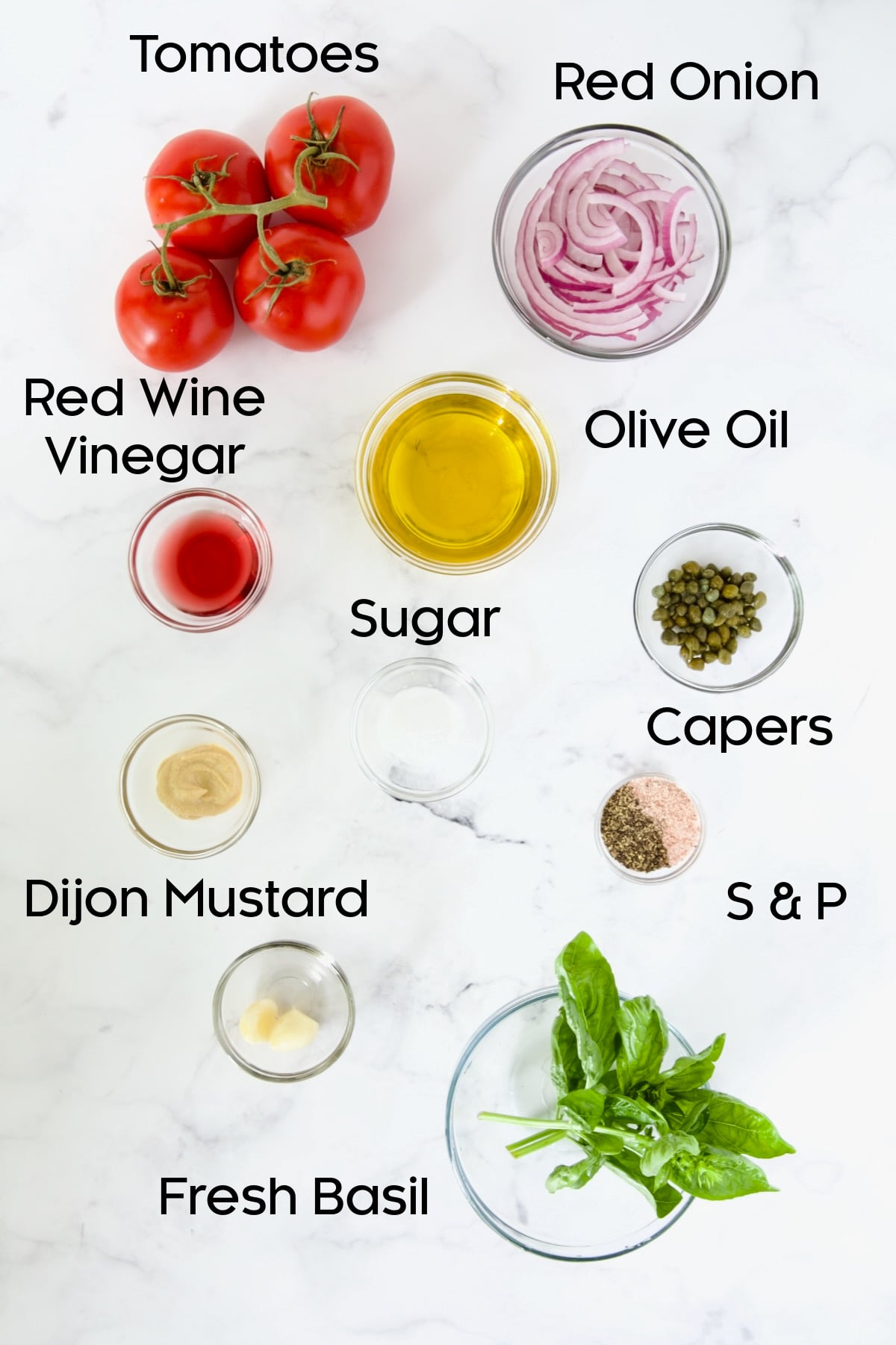Ingredients for Tomato Onion Salad in glass bowls.