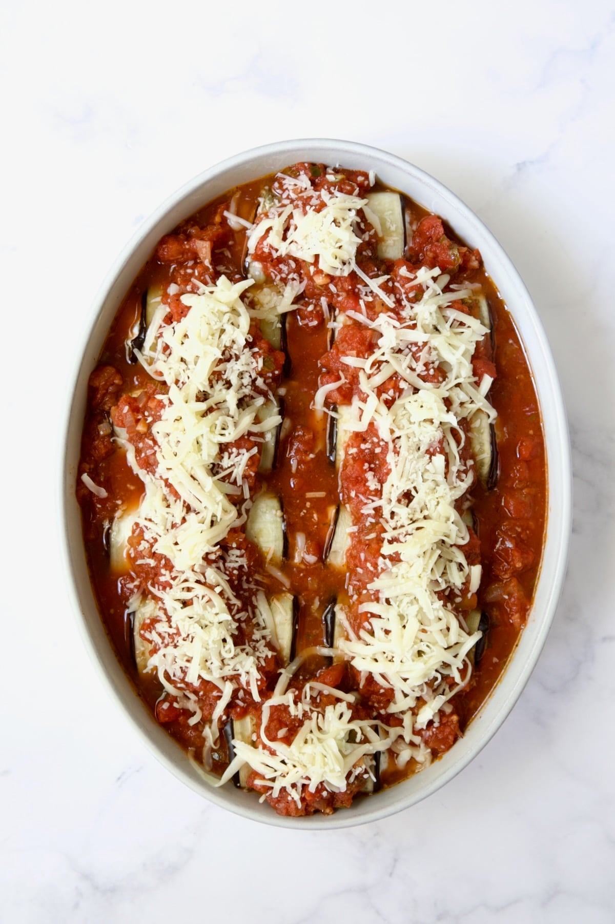 Assembled Four-Cheese Eggplant Rollatini before being baked.
