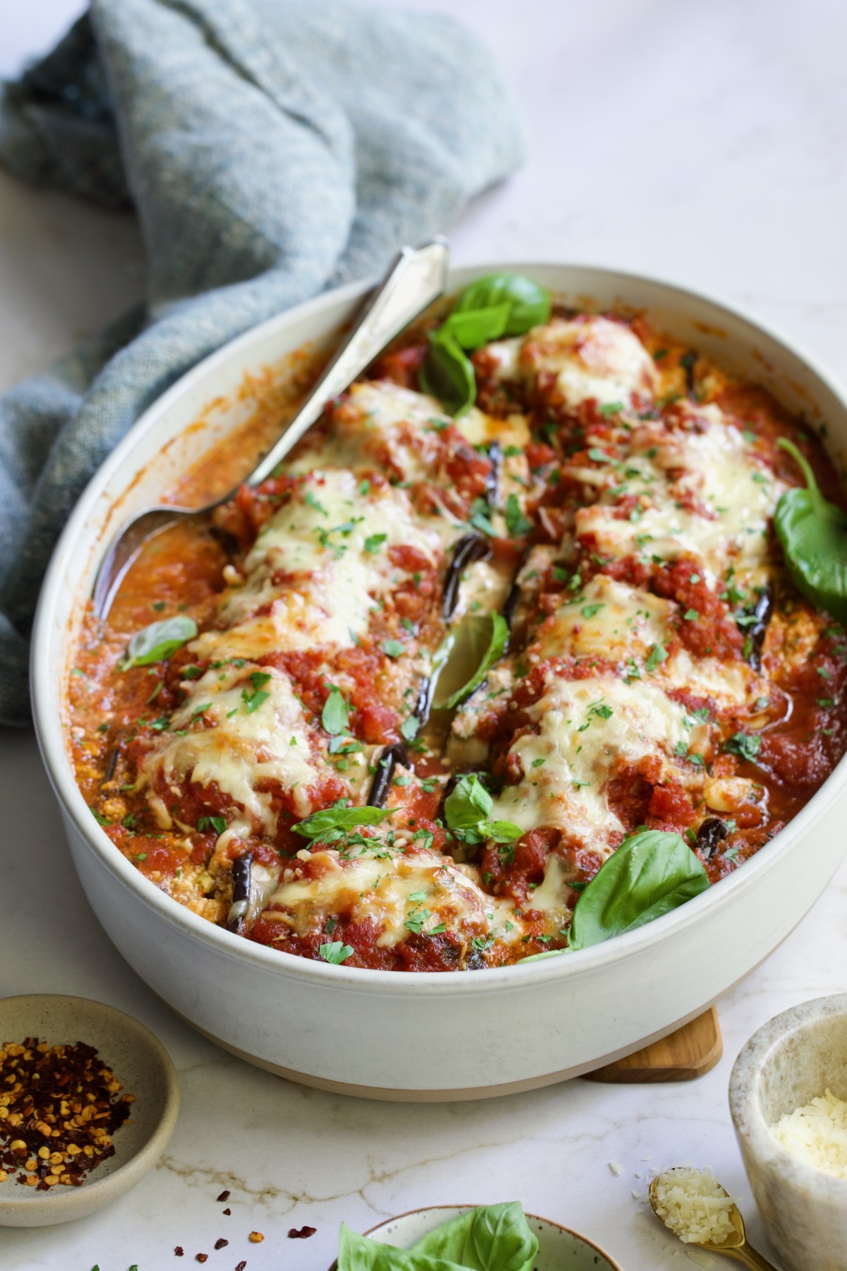 Baked Four-Cheese Eggplant Rollatini with serving spoon.