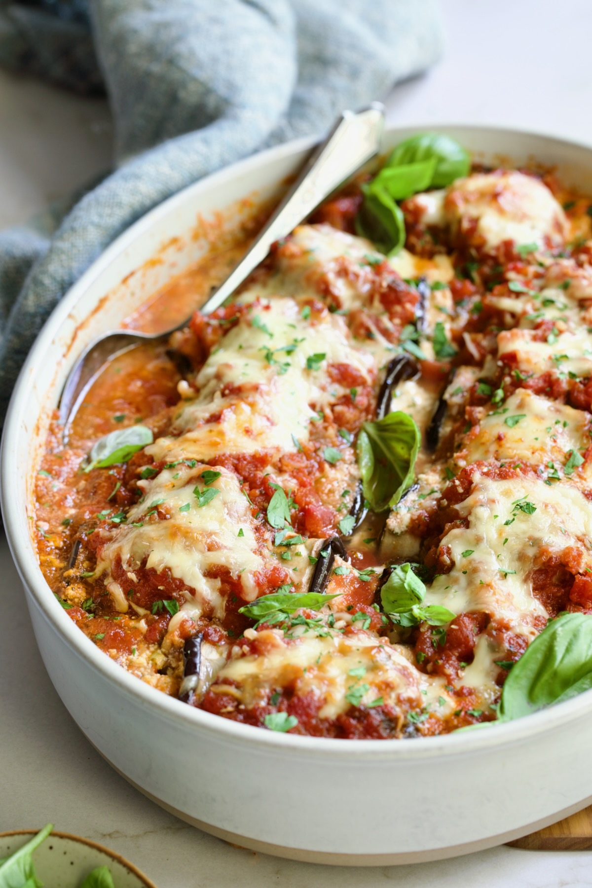 Baked Four-Cheese Eggplant Rollatini with serving spoon.