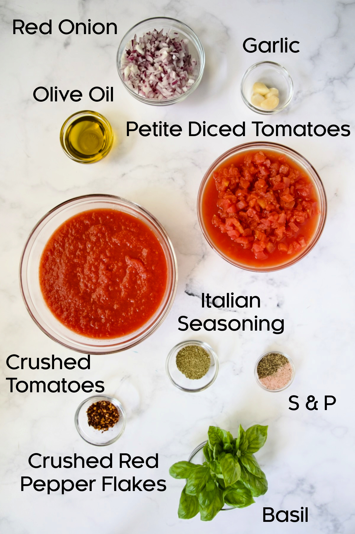 Ingredients for the sauce for Four-Cheese Eggplant Rollatini in glass bowls on marble countertop.