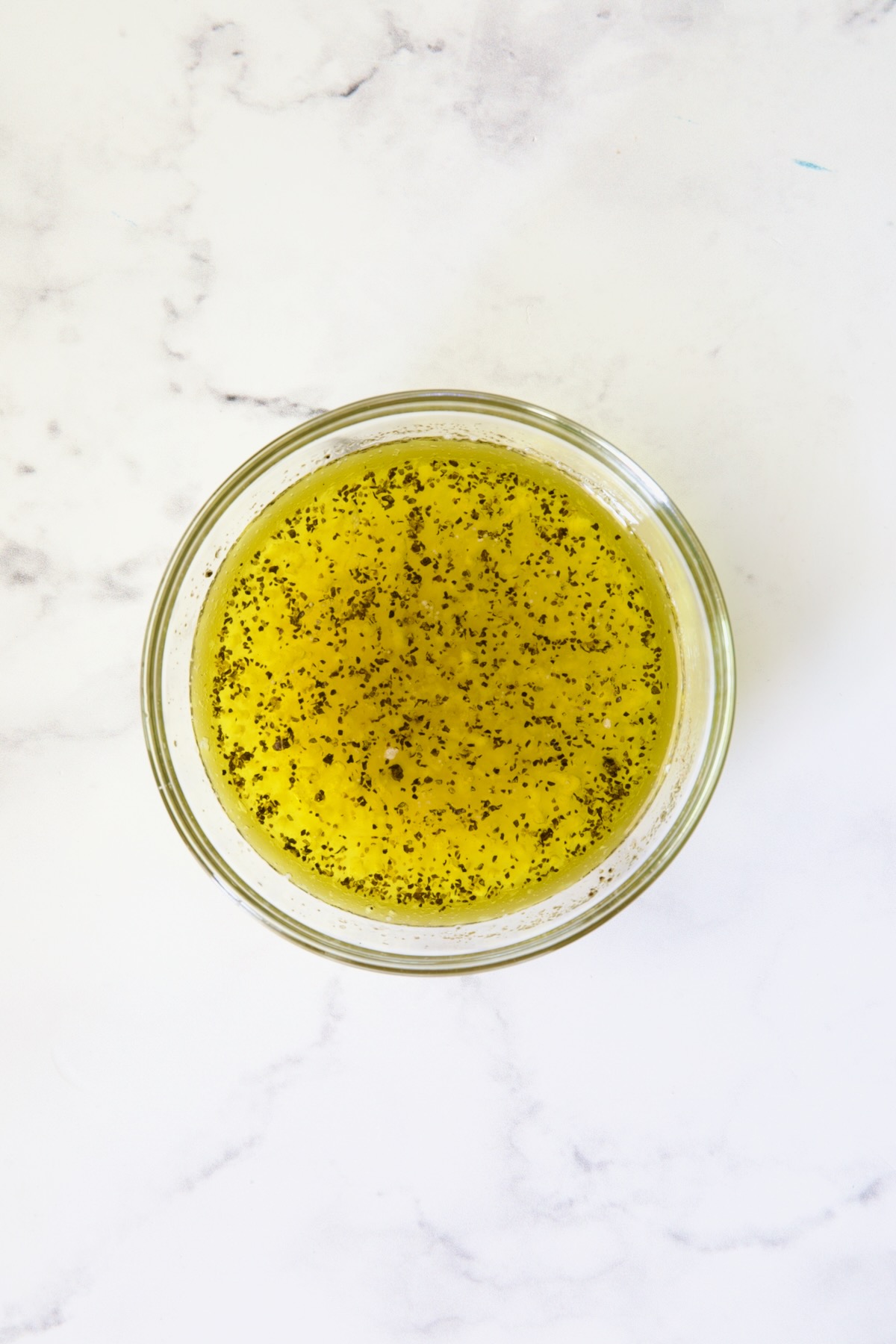 Dressing for tabbouleh in glass bowl.