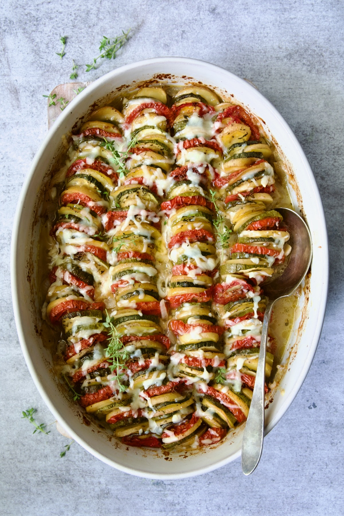 Baked Vegetable Tian with melted cheese on top.