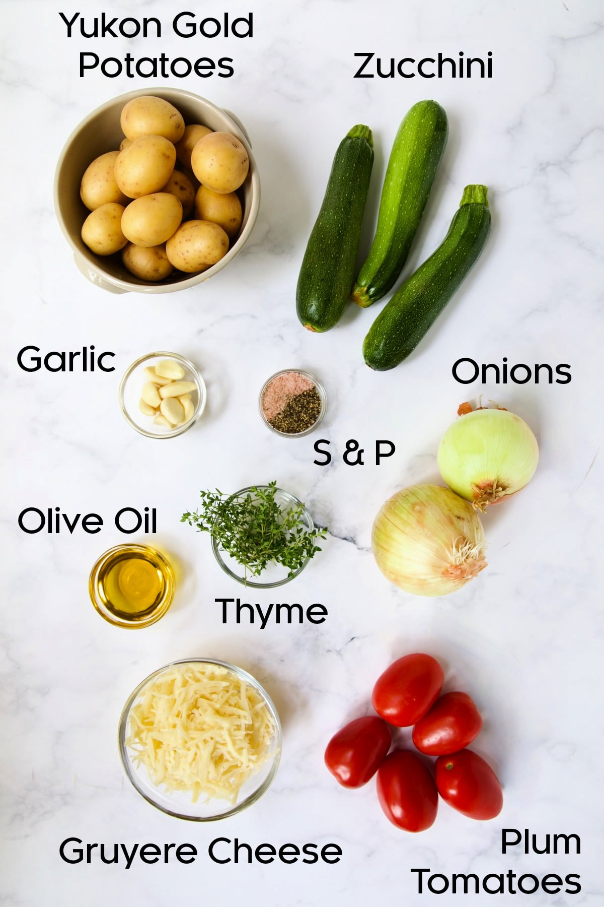 Ingredients for Vegetable Tian on marble countertop.